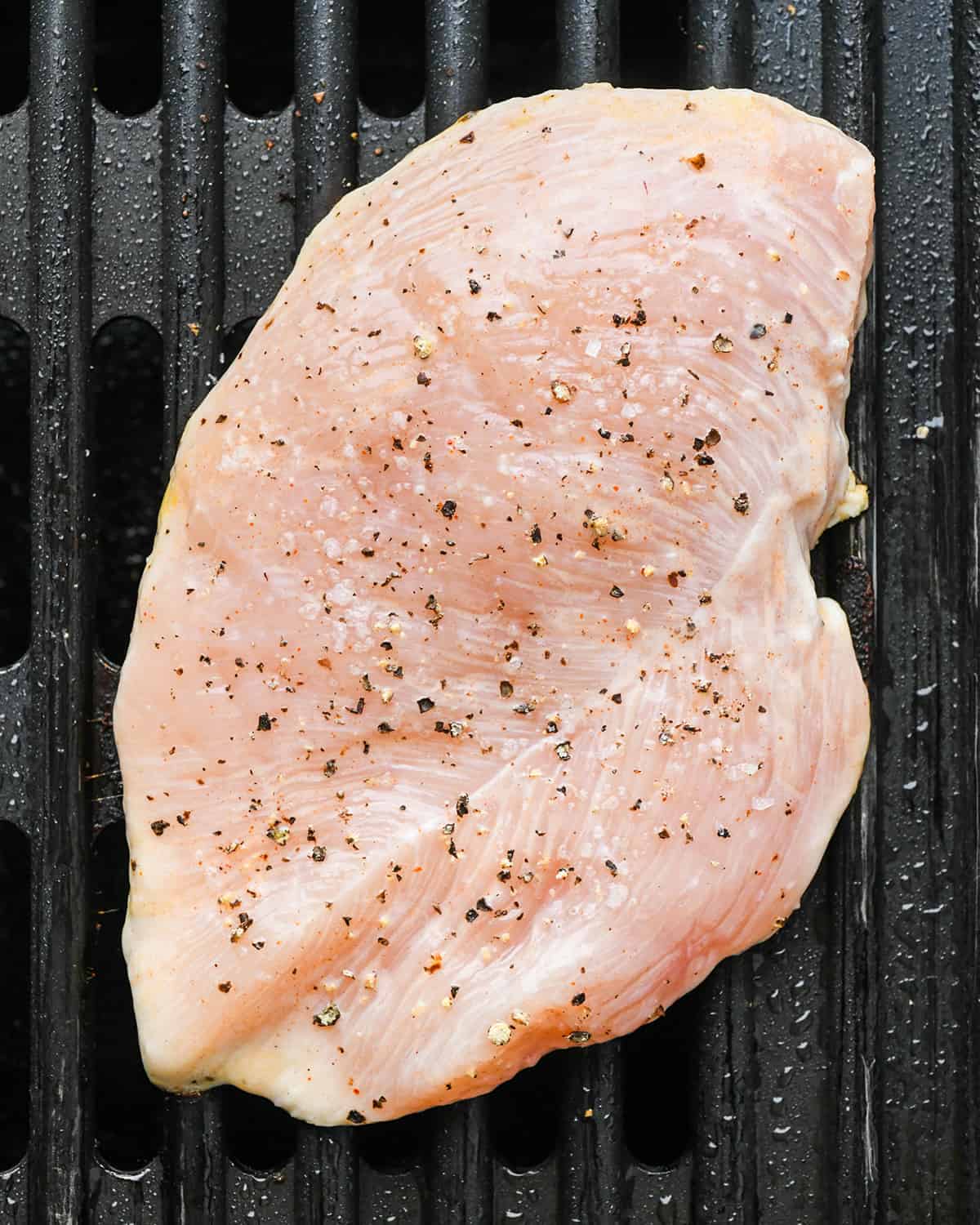 Buttermilk Chicken being cooked on the first side on a grill pan