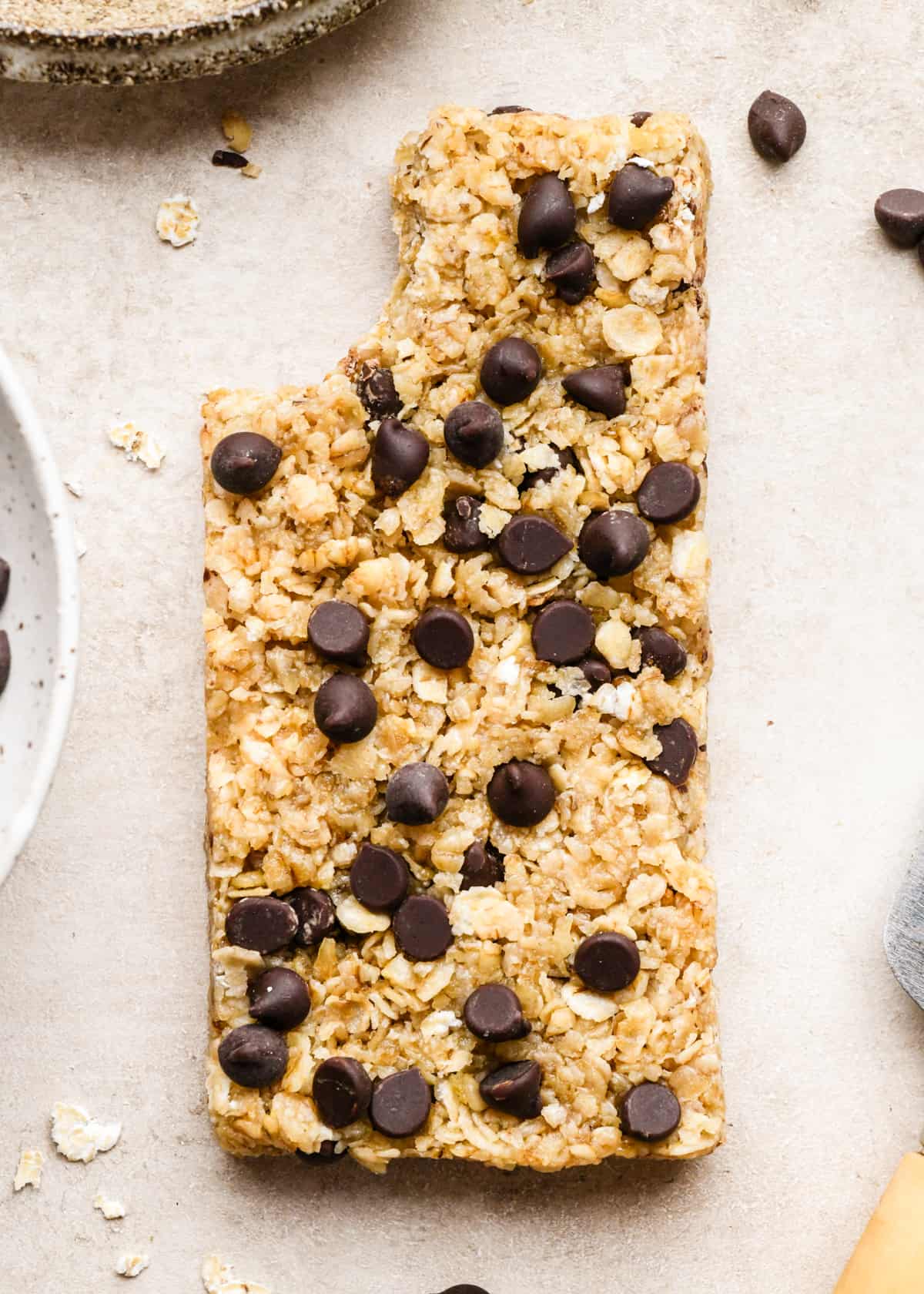 a homemade granola bar with chocolate chips and a bite taken out of it