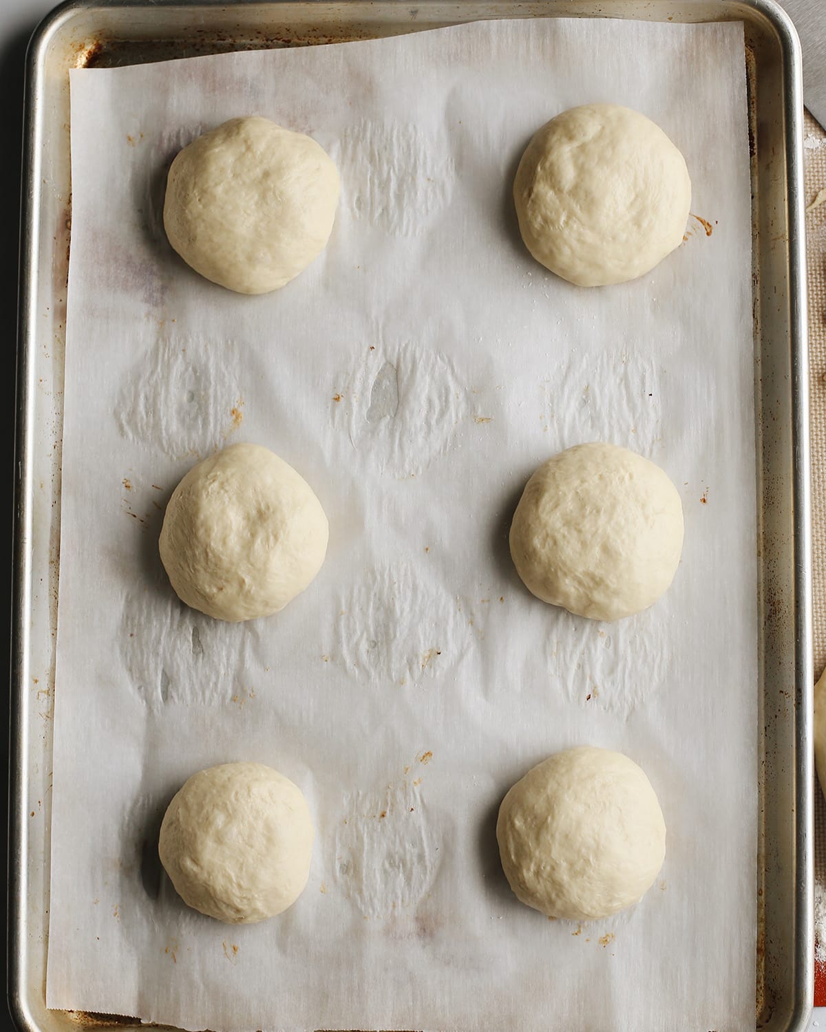 How to Make Homemade Hamburger Buns - buns rising on baking sheet