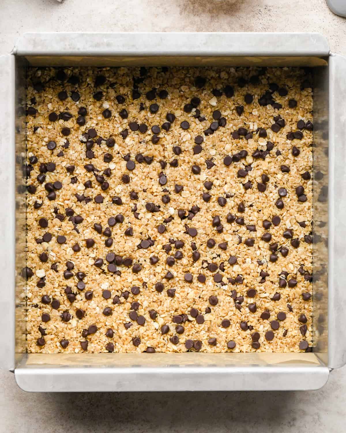 granola bars in a baking dish topped with mini chocolate chips