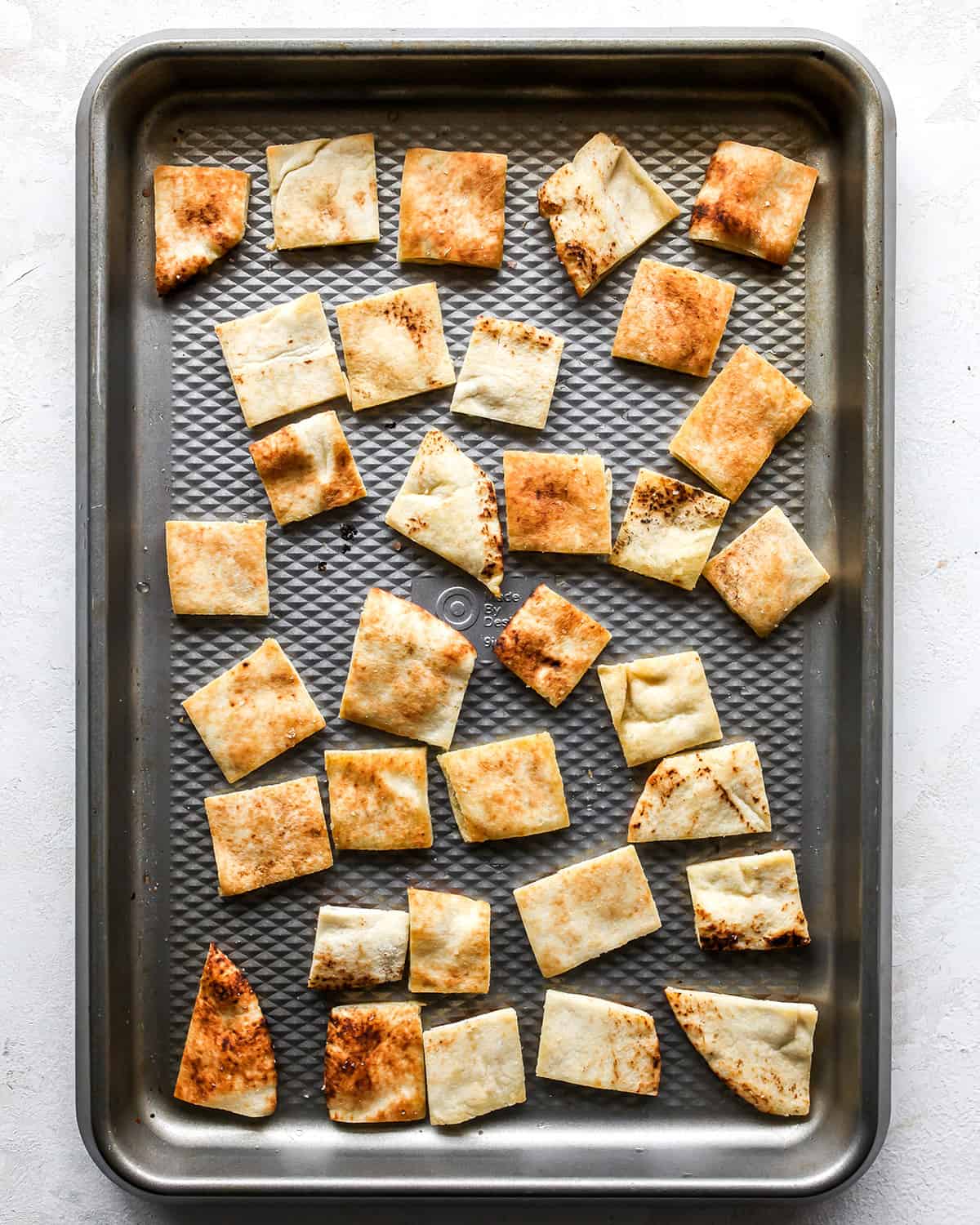 how to make greek salad - pita croutons on a baking sheet after baking