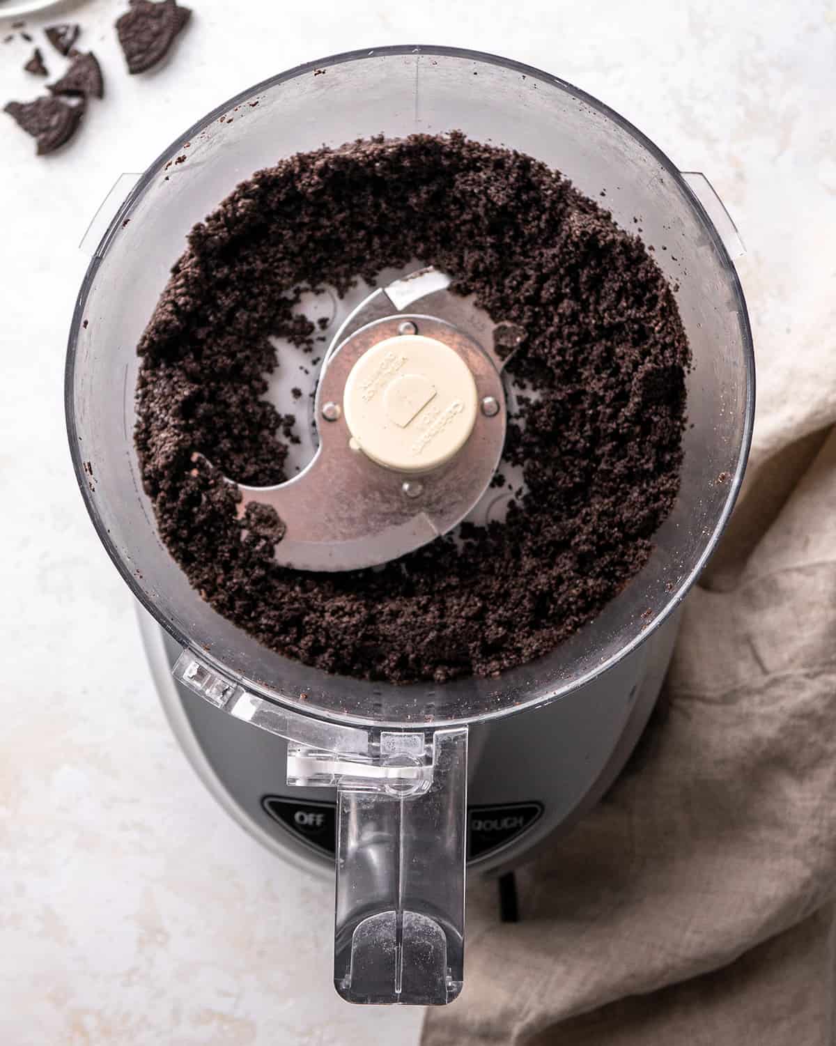 oreo crumbs in a food processor after processing to make oreo pie