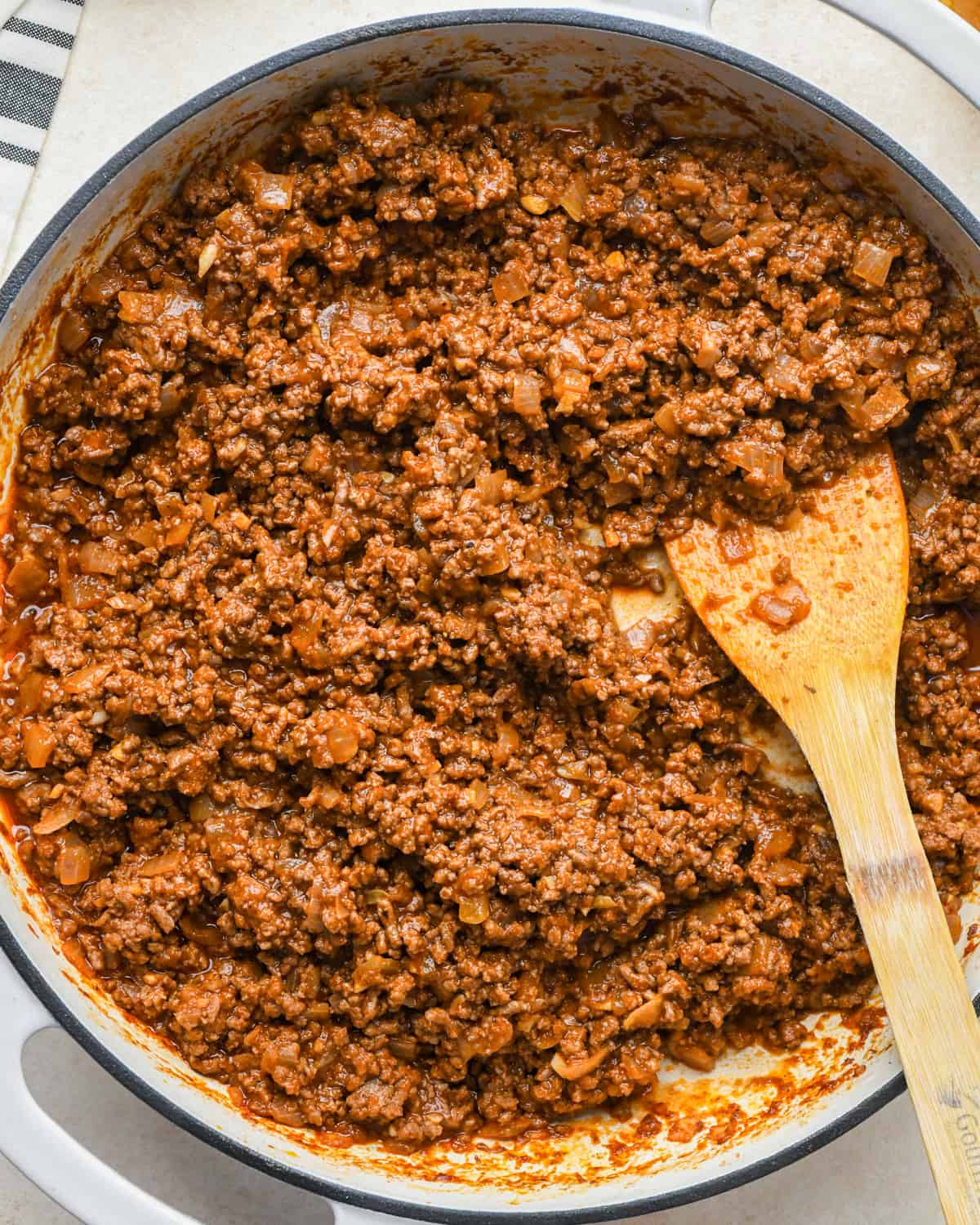 How to Make Sloppy Joes - adding tomato sauce, honey, salt, pepper and paprika after stirring