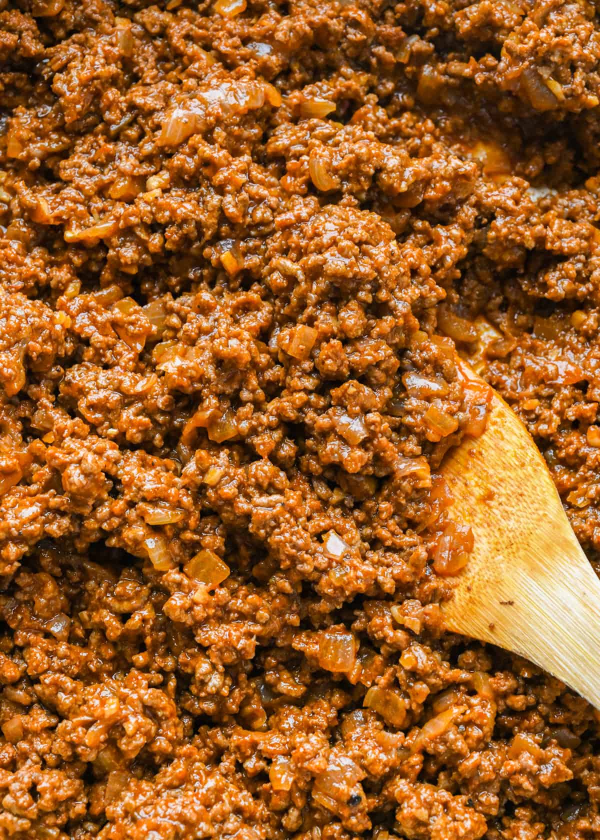 up close photo of Sloppy Joes Recipe in a pot with a wooden spoon