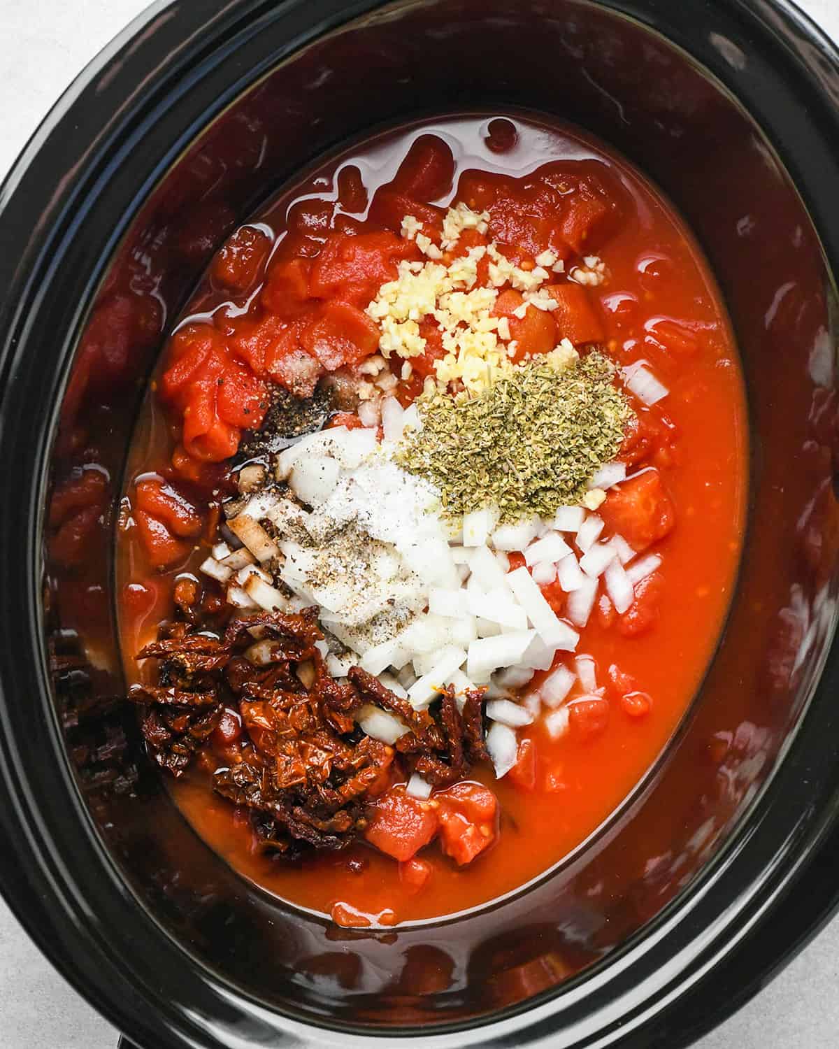 Slow Cooker Italian Chicken sauce ingredients in a crockpot before mixing