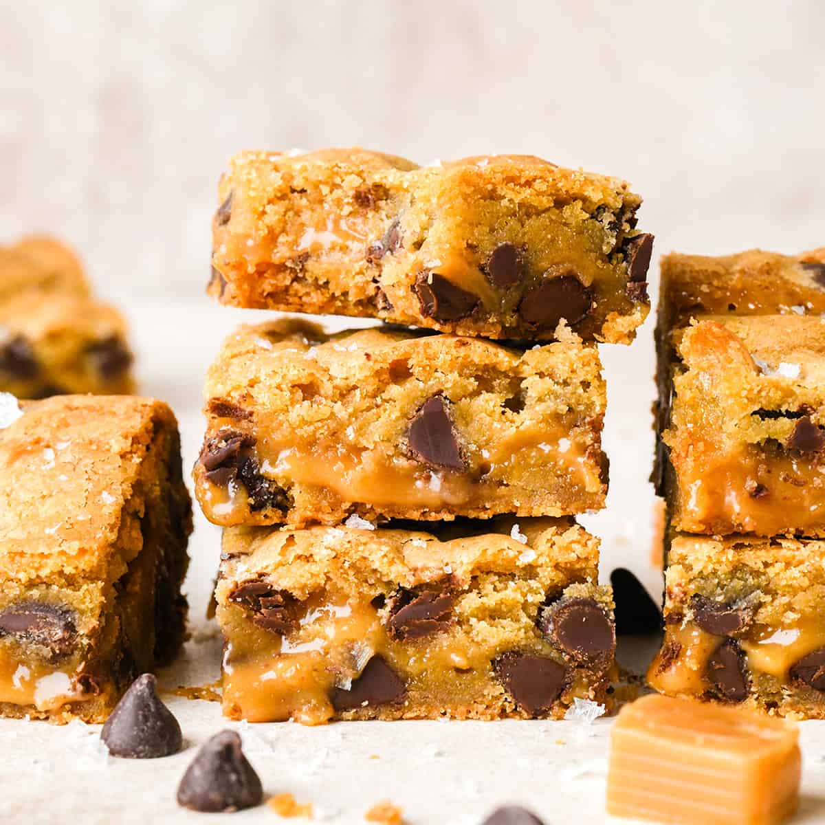 a stack of 3 Caramel Cookie Bars, the top one has a bite taken out of it