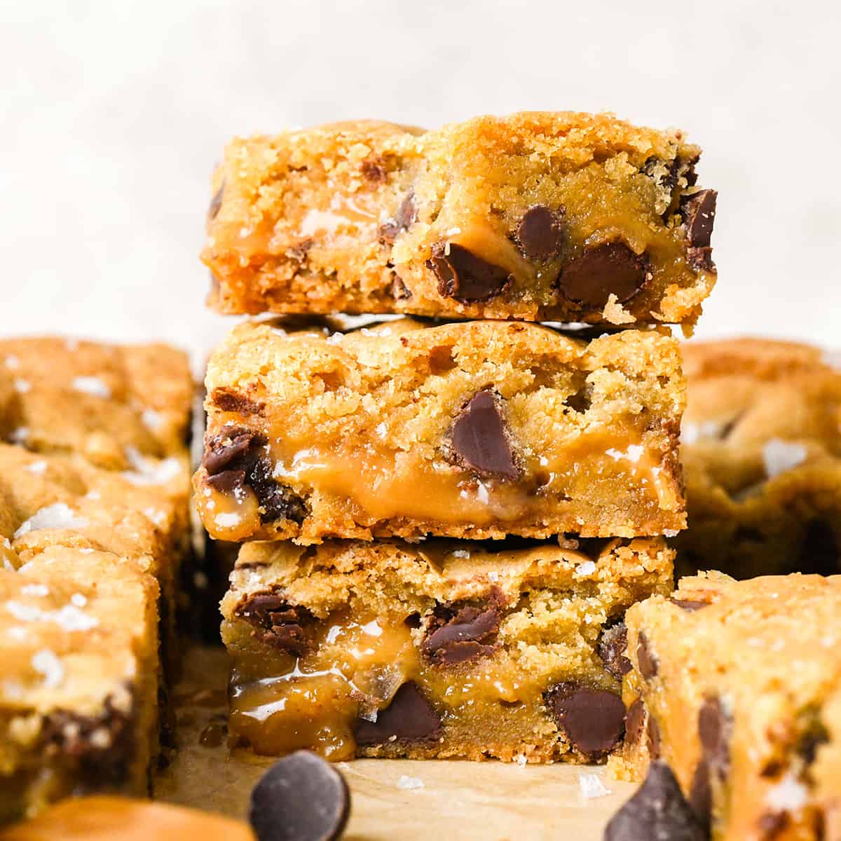 a stack of 3 Caramel Cookie Bars, the top one has a bite taken out of it