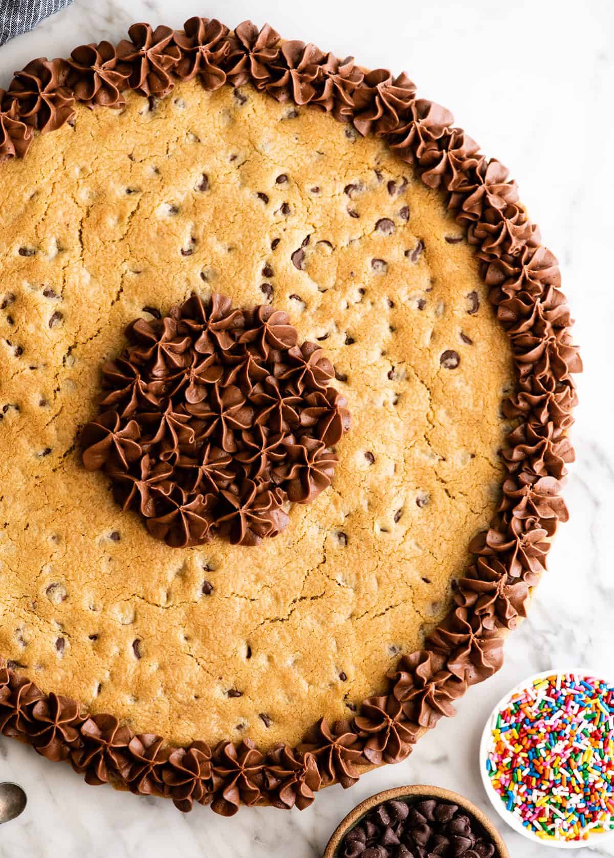 overhead photo of a chocolate chip cookie cake with chocolate frosting