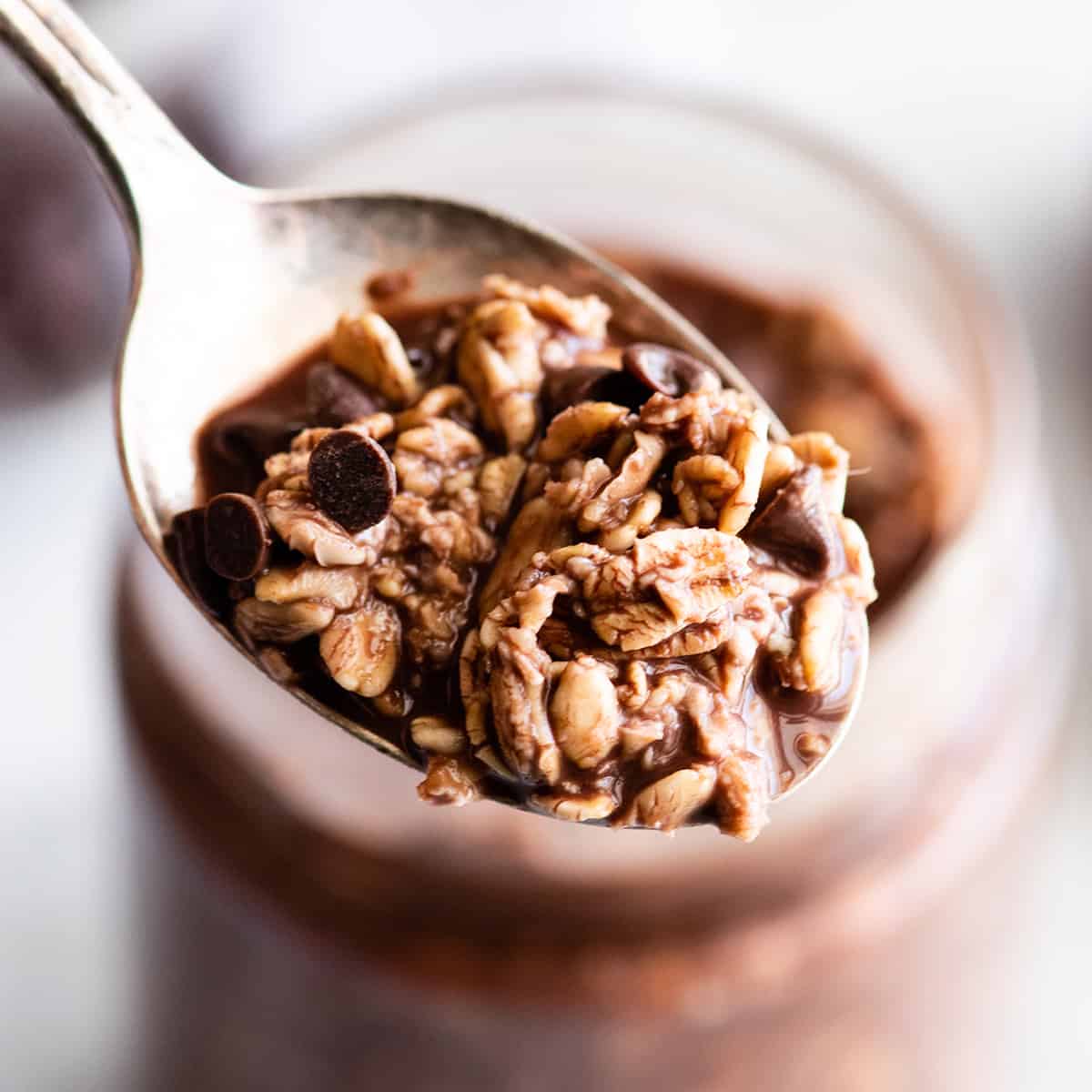 a bite of chocolate overnight oats on a spoon