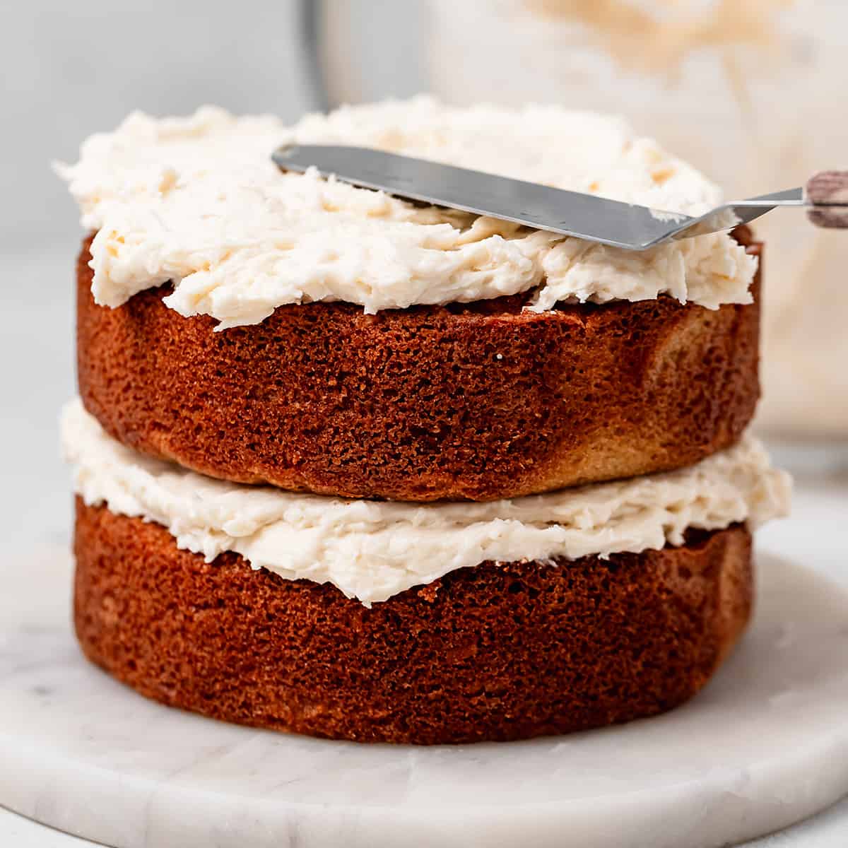 frosting a Coconut Cake with coconut frosting