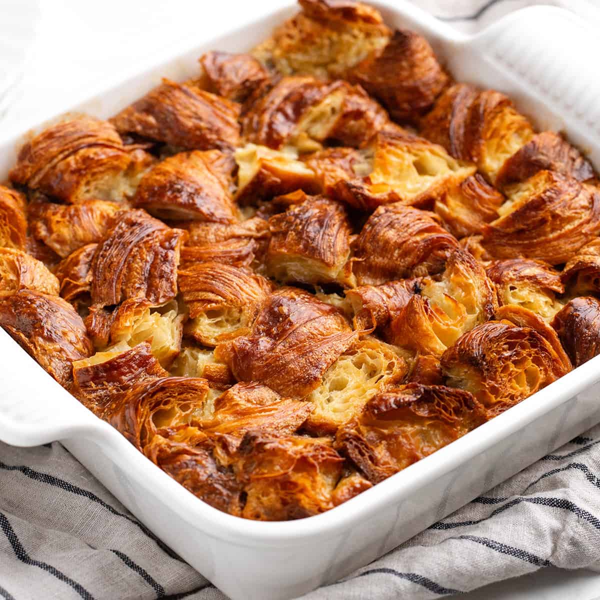 Croissant Bread Pudding in a white square baking dish