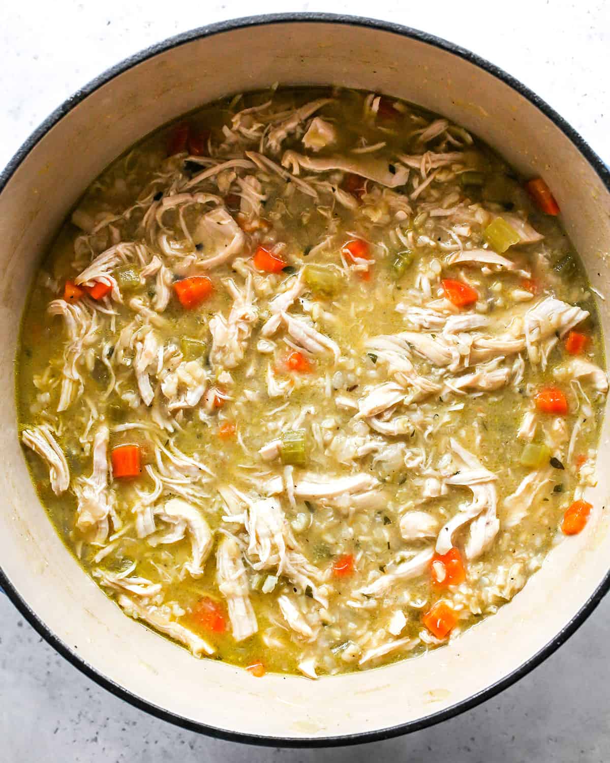 how to make Chicken Rice Soup - shredded chicken added back to the pot after stirring