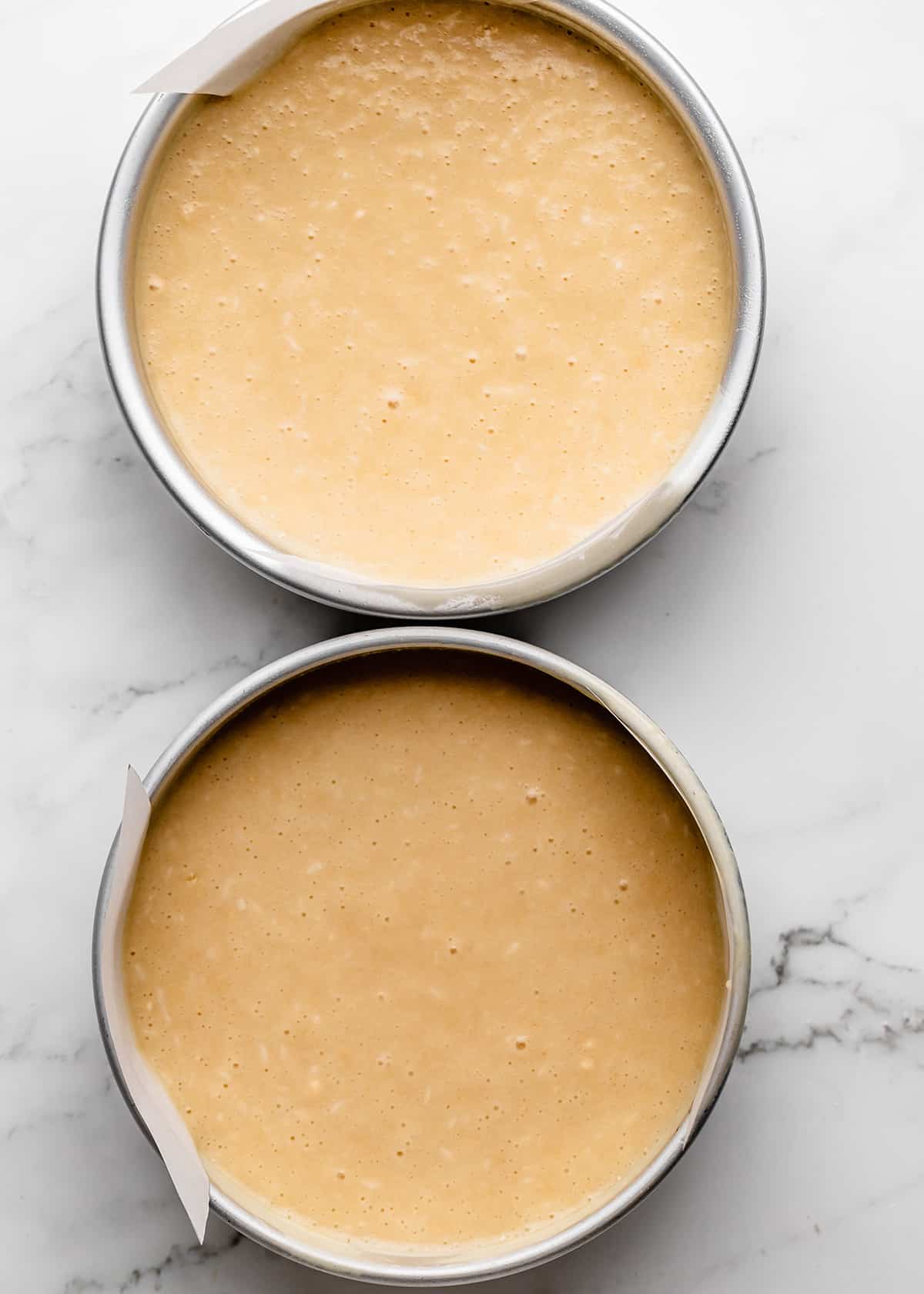 how to make coconut cake- batter in two cake pans before baking