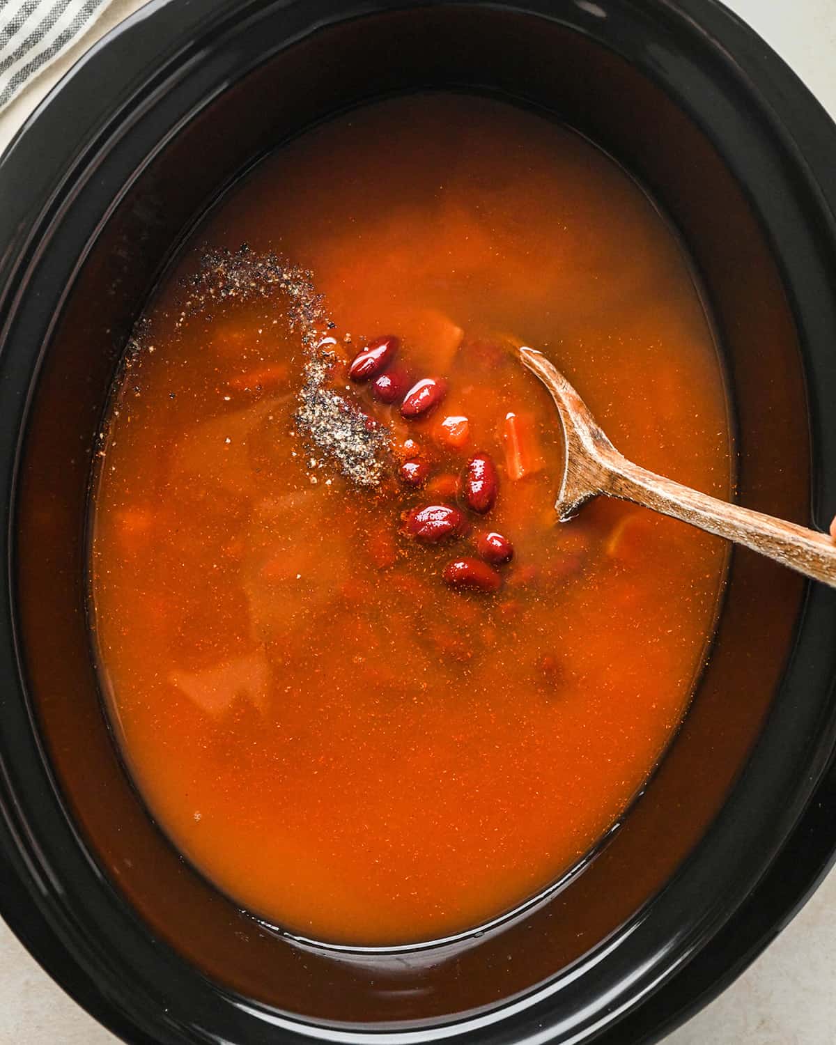 How to Make Hamburger Soup - ingredients added to the crock pot before stirring