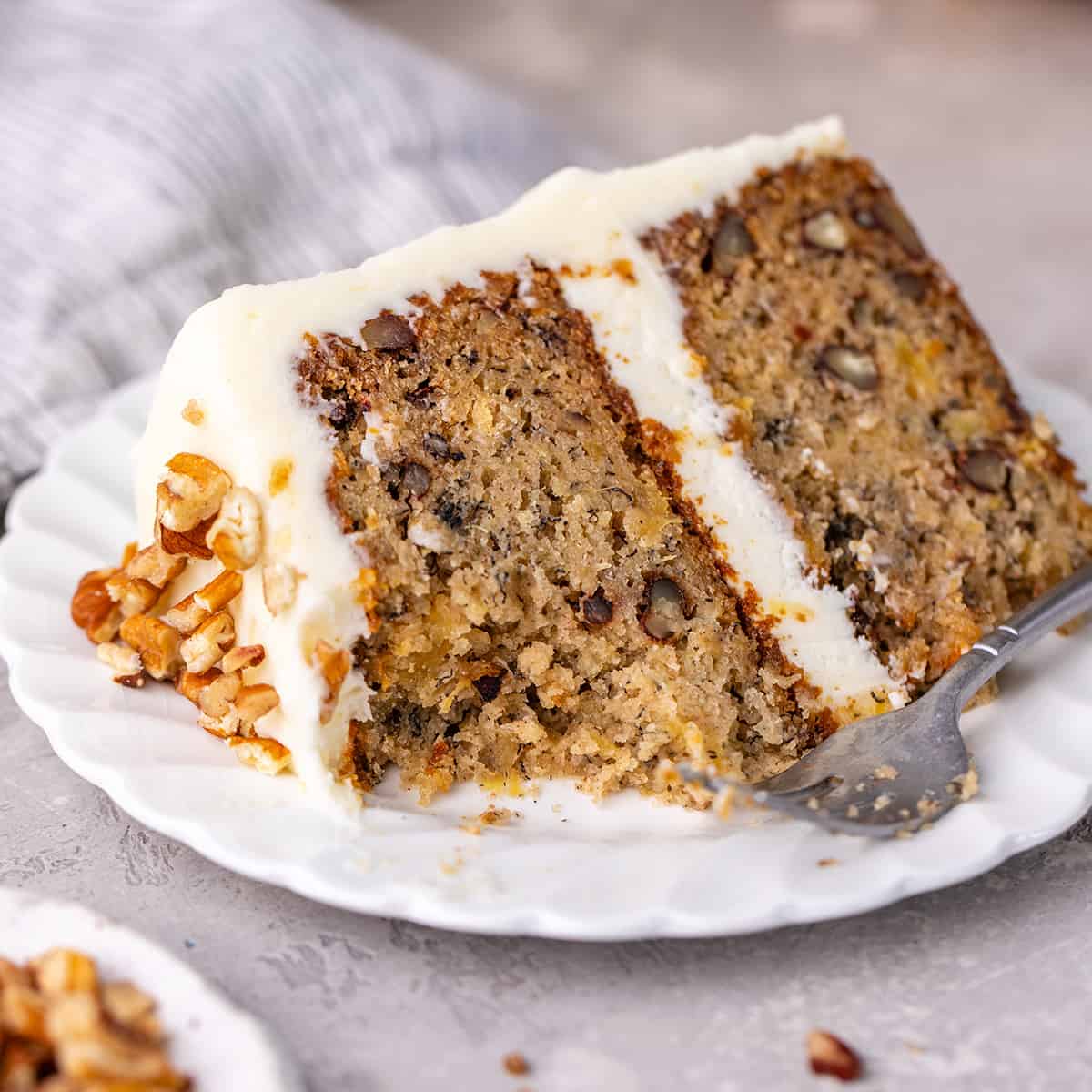 hummingbird cake on a plate with a bite taken out of it