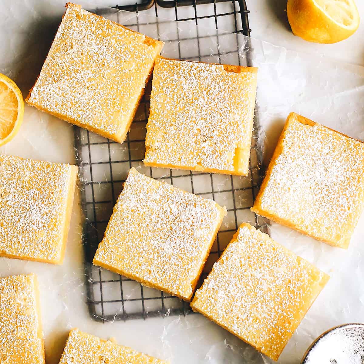 overhead photo of 7 lemon squares with powdered sugar