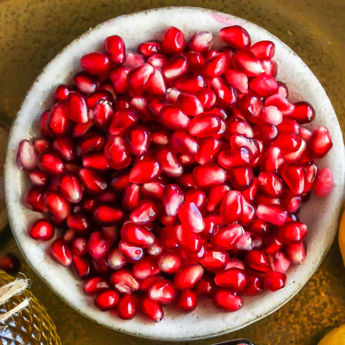 a bowl of pomegranate seeds to make Pomegranate Dressing