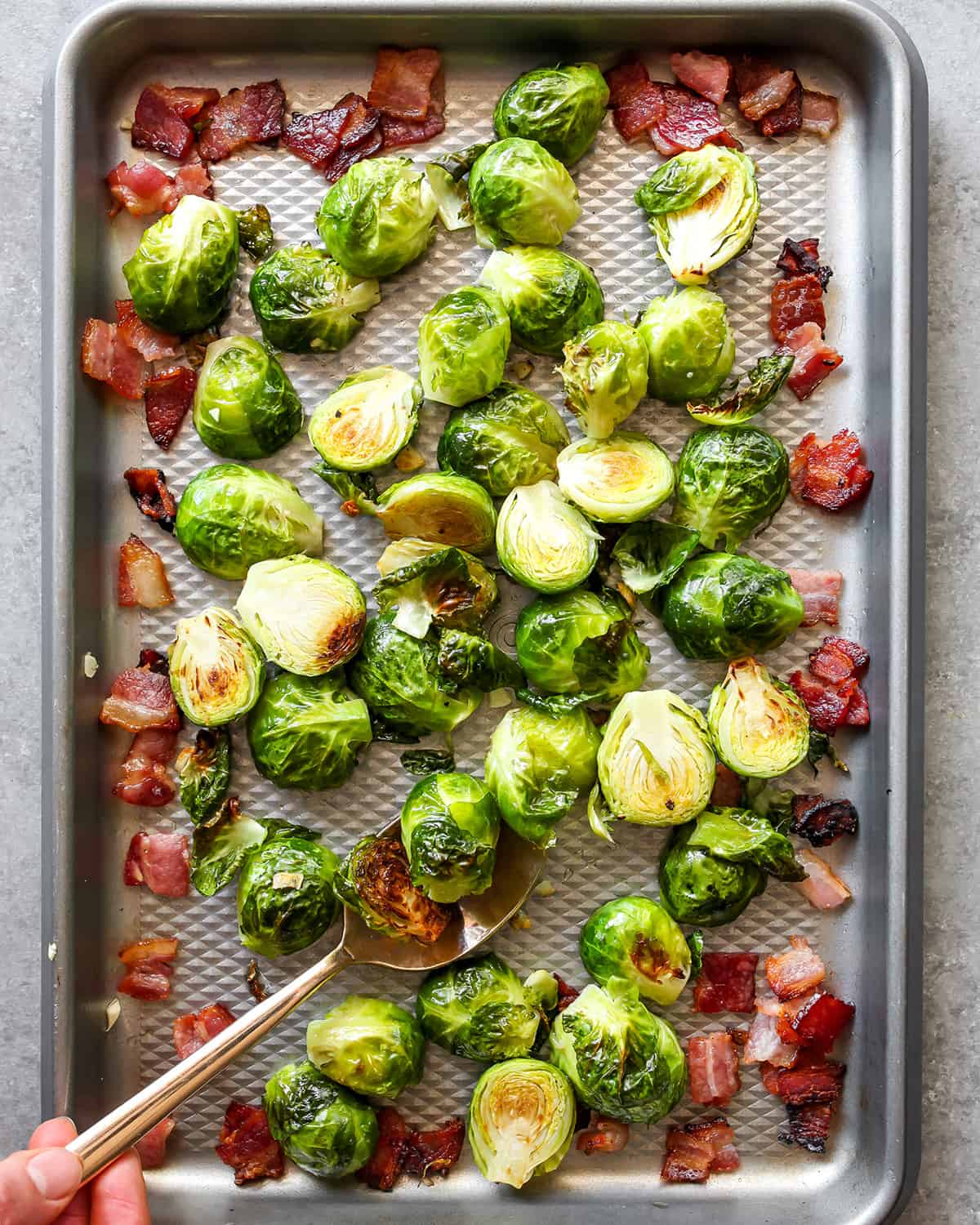 how to make brussel sprouts with bacon - ingredients on a pan after roasting 20 minutes