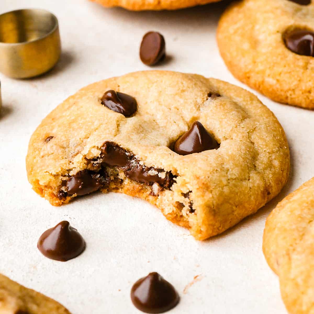 a Vegan Chocolate Chip Cookie with a bite taken out of it