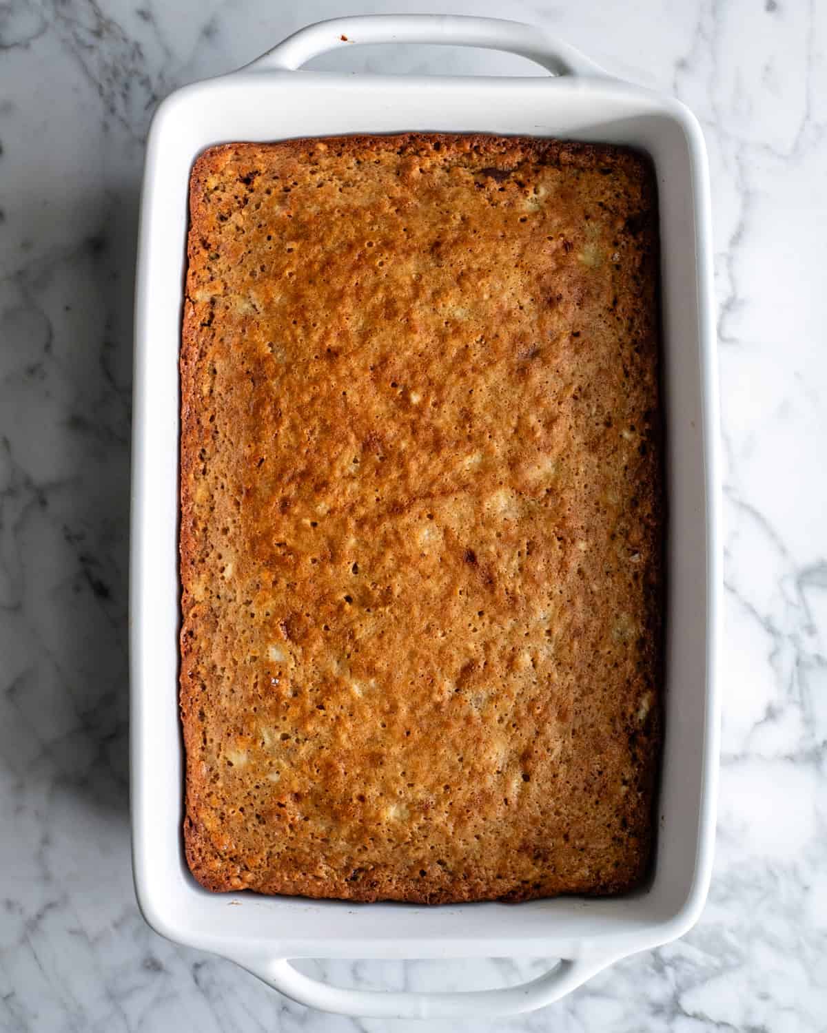 baked banana cake in a cake pan before frosting