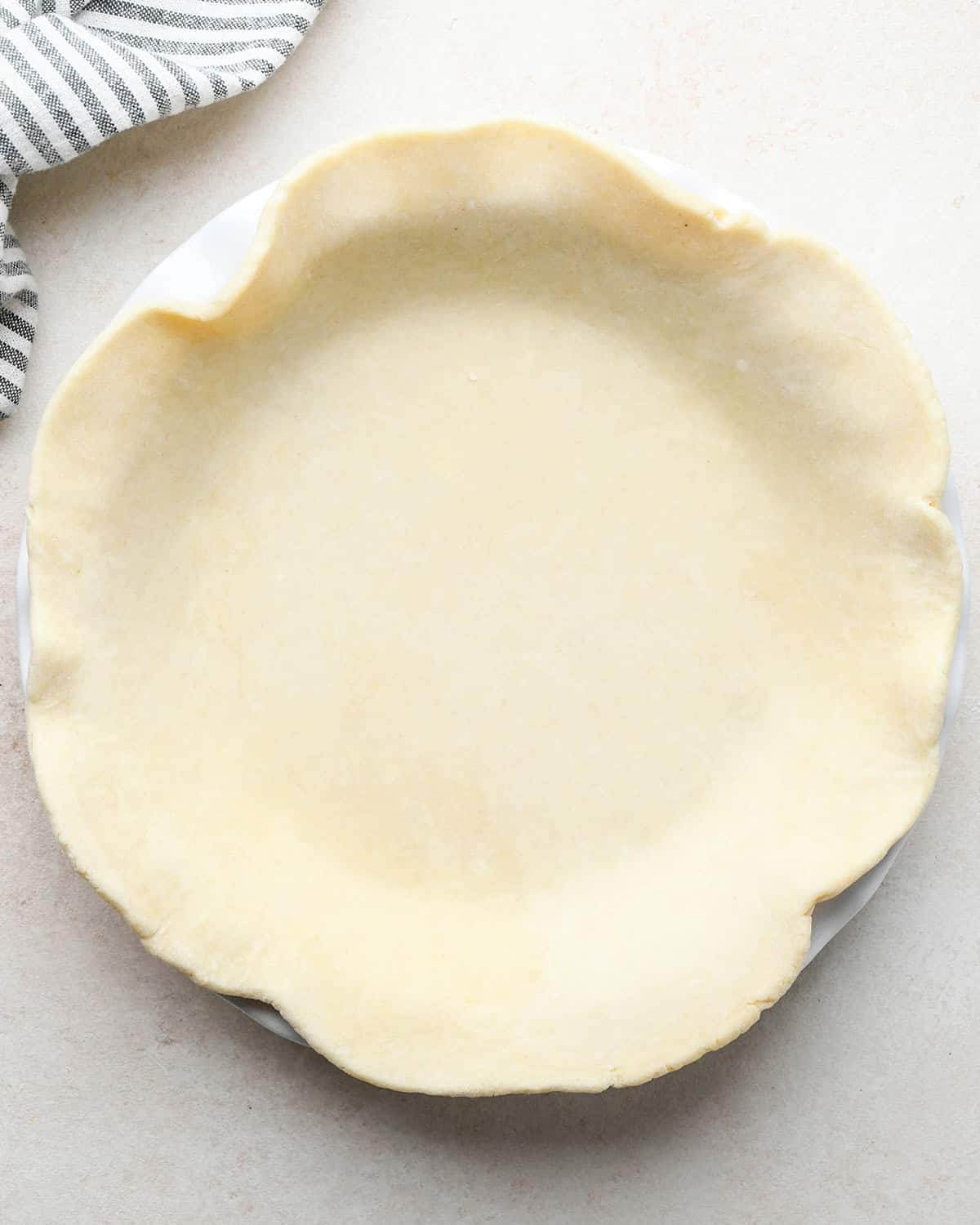 quiche crust rolled out into a circle inside a pie dish
