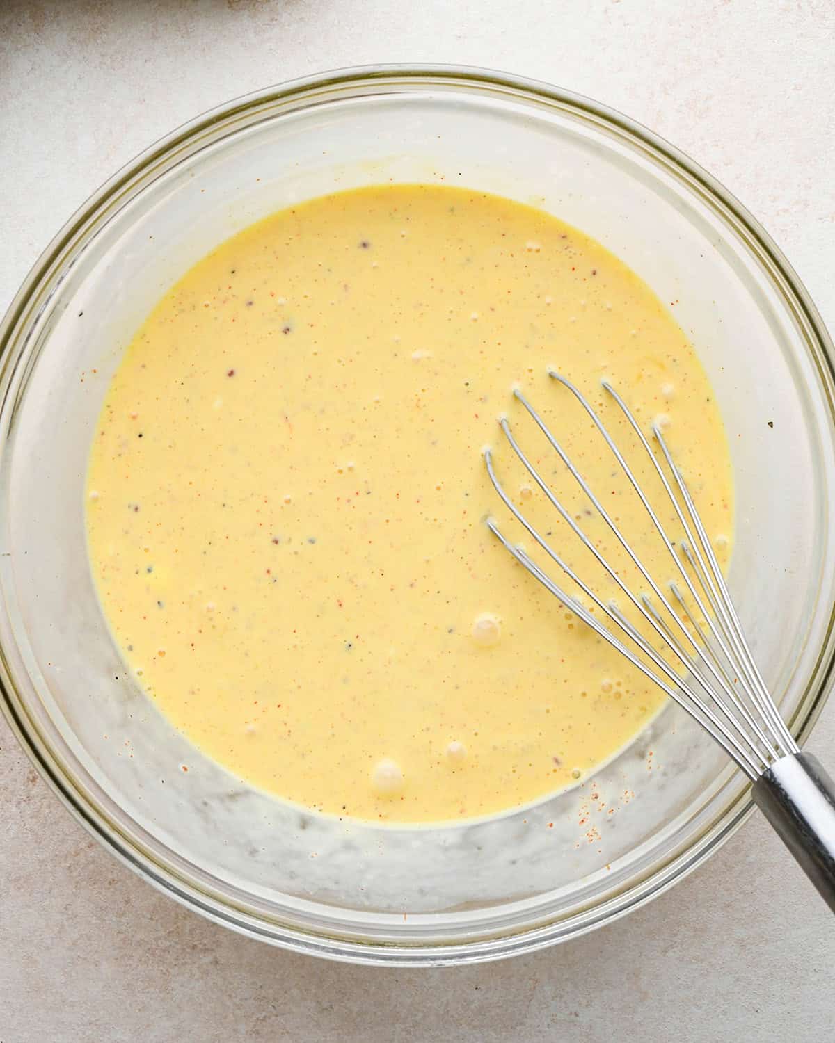 how to make quiche - filling ingredients in a bowl after whisking