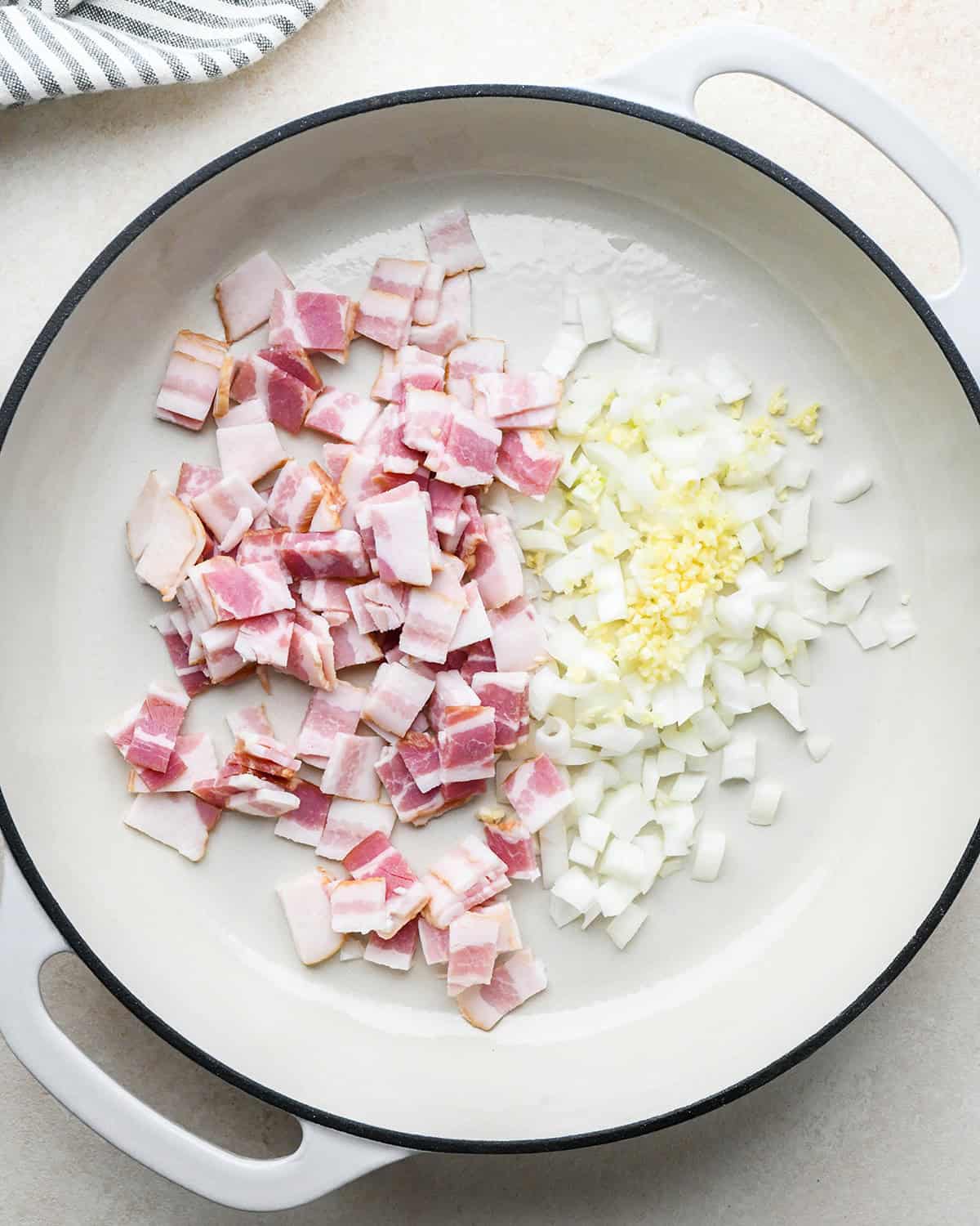 bacon, onion and garlic in a pan before cooking to make bacon quiche