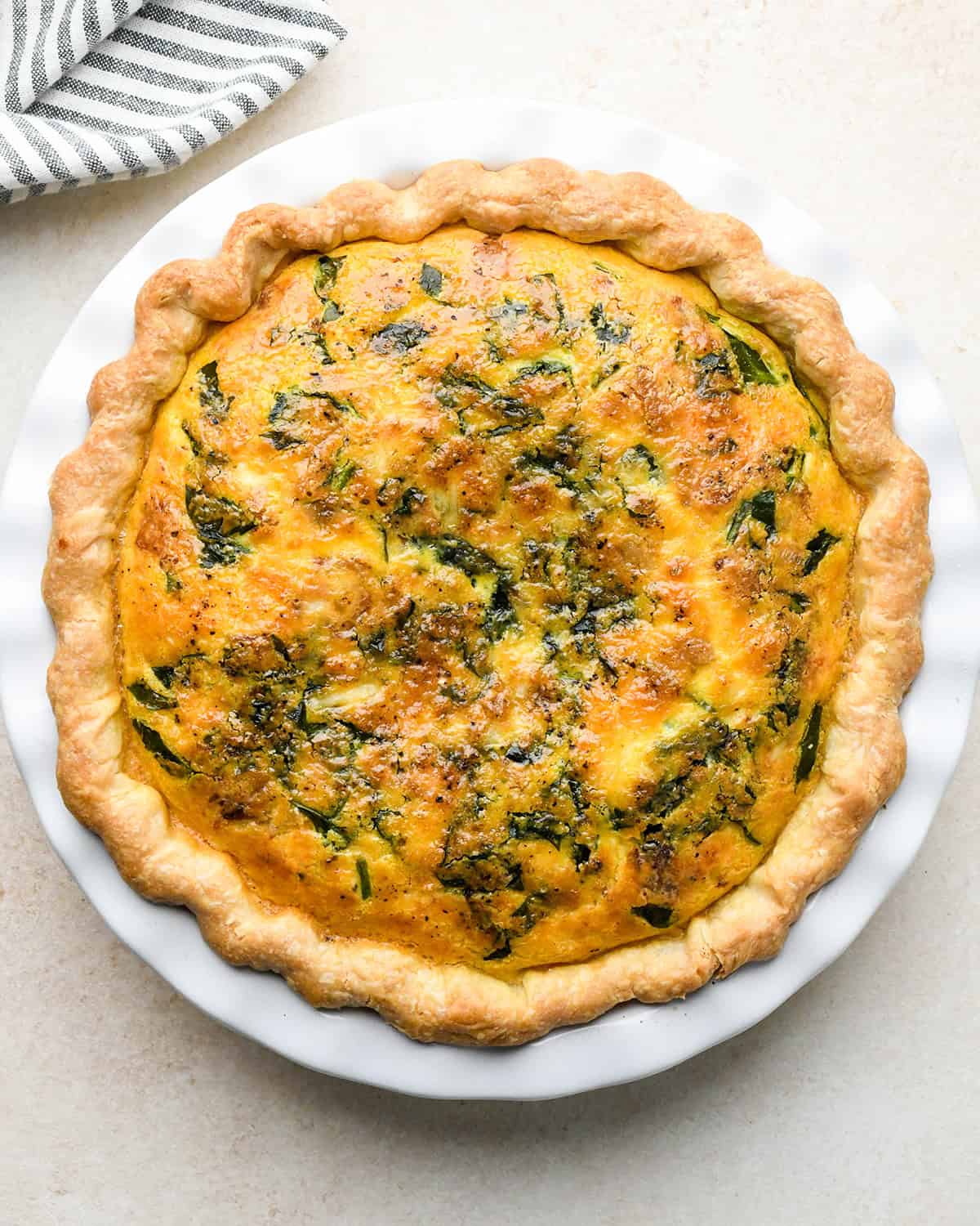 bacon spinach quiche in a pie dish after baking