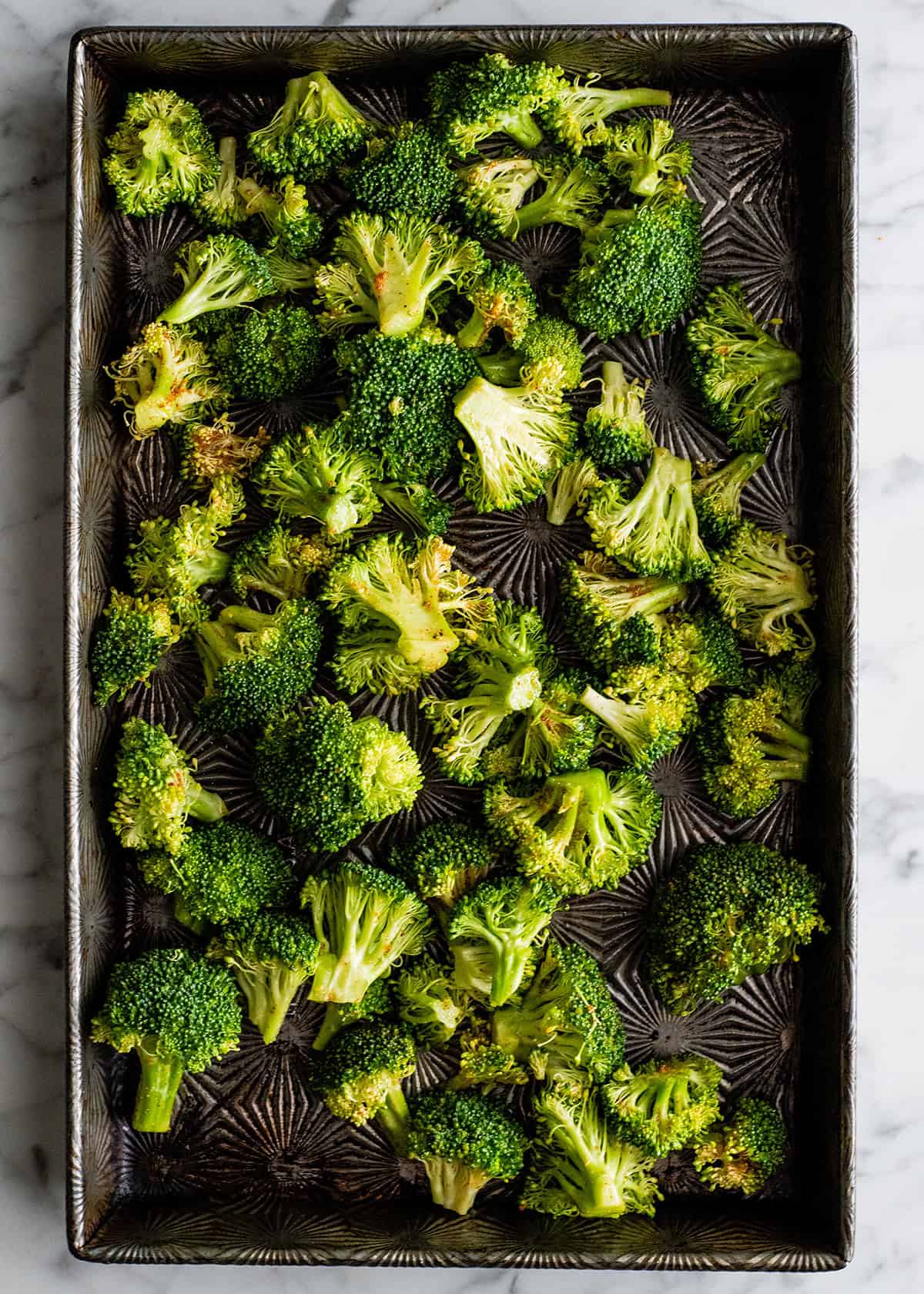 how to roast broccoli in the oven - broccoli on a baking sheet before roasting