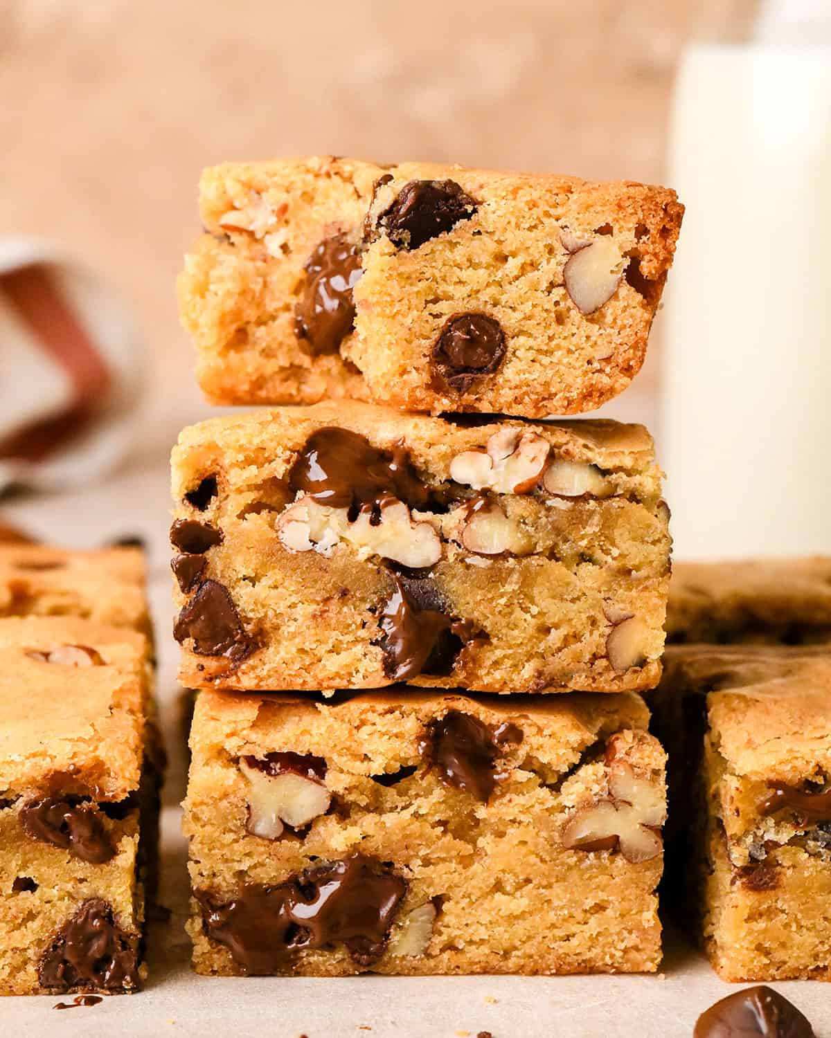 a stack of 3 Browned Butter Blondies, the top one has a bite taken out of it