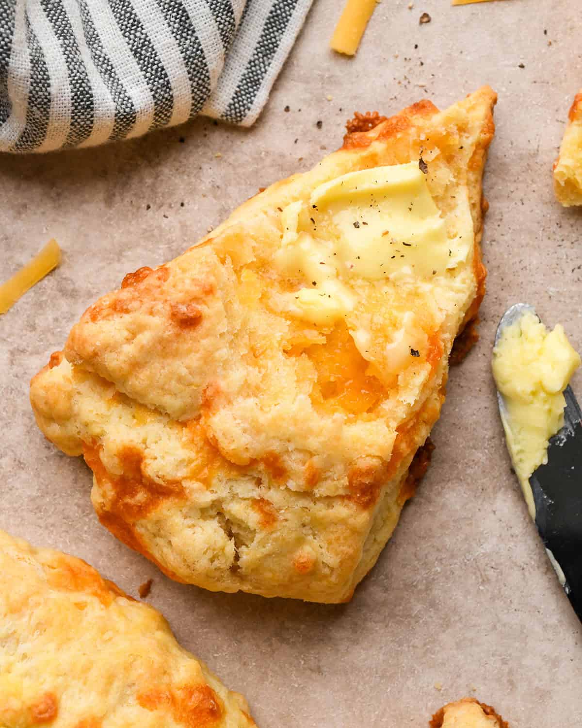 one Cheese Scone with butter spread on top