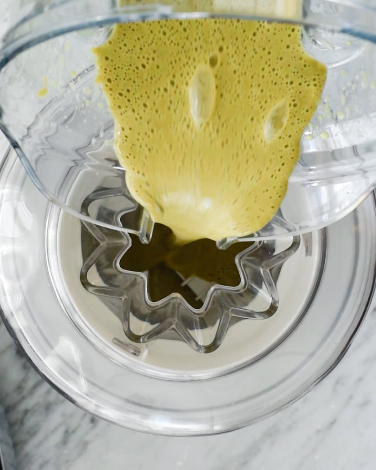 Dairy Free Matcha Ice Cream mixture being poured into an ice cream maker