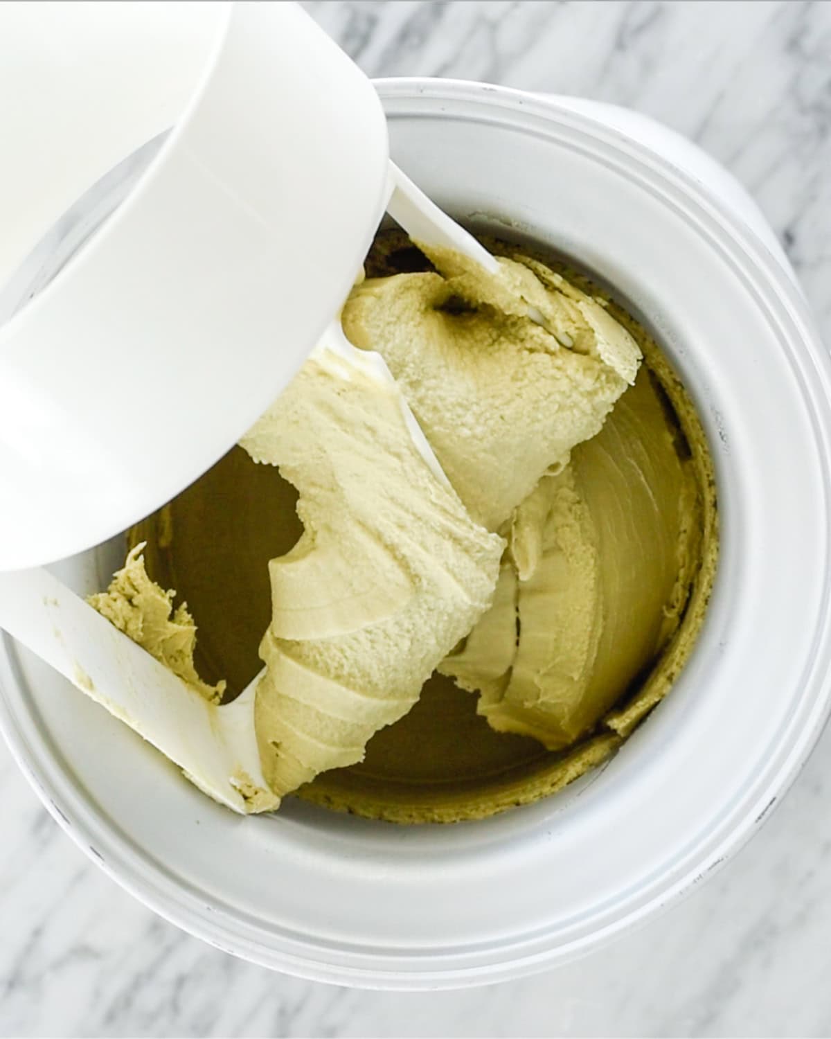 Dairy Free Matcha Ice Cream in an ice cream maker after churning