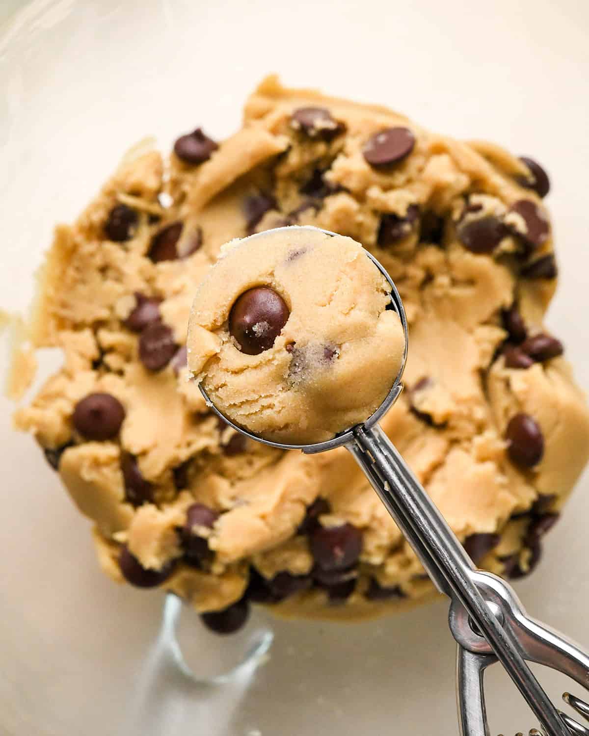 How to Make Eggless Chocolate Chip Cookies - a cookie scoop portioning out dough