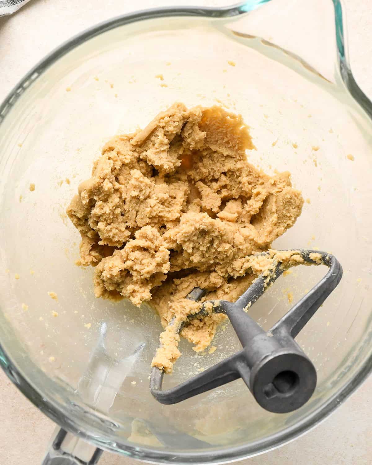 How to Make Eggless Chocolate Chip Cookies - butter, brown sugar and white sugar in a bowl after mixing