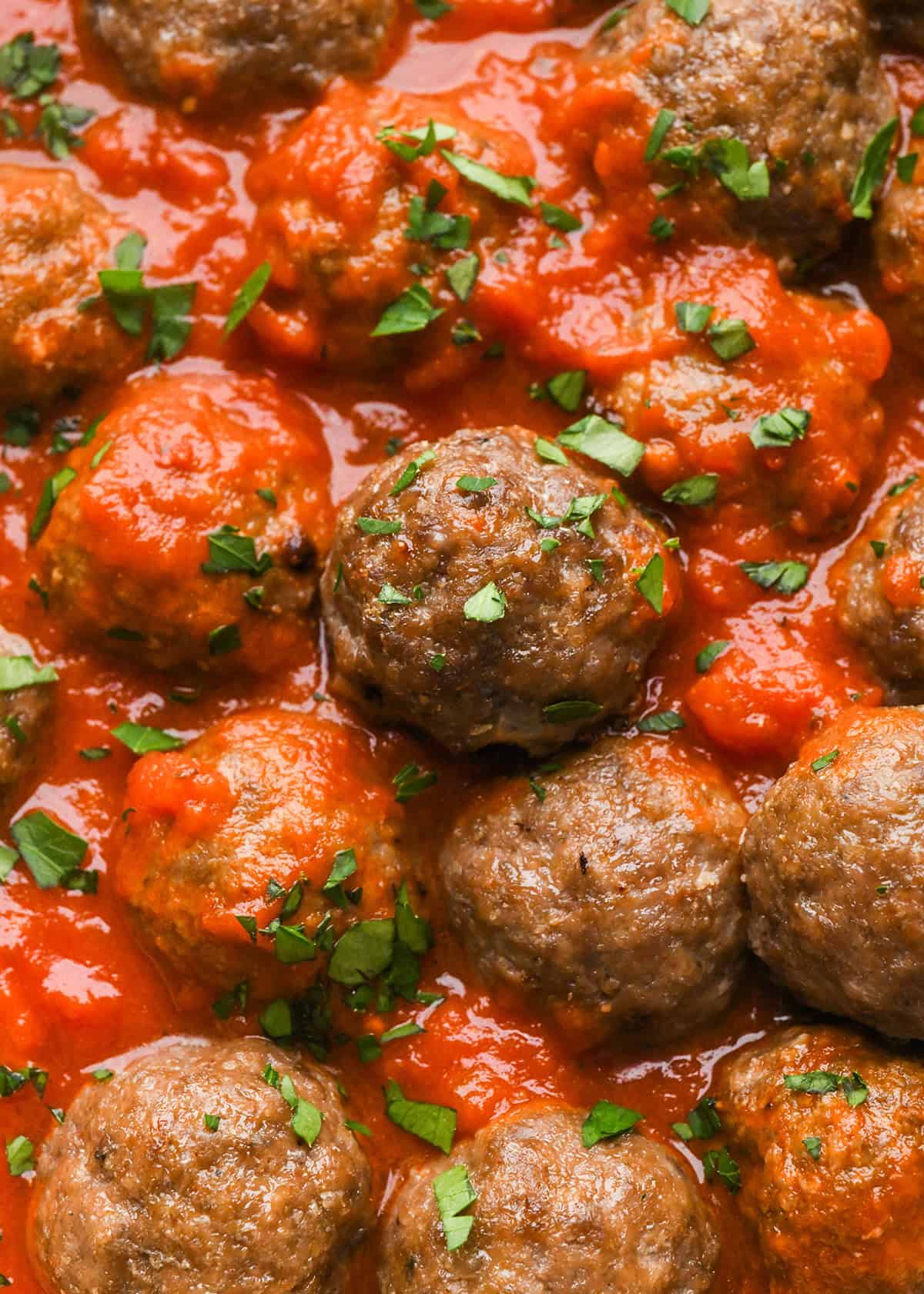 Gluten Free Meatballs in marinara sauce garnished with basil