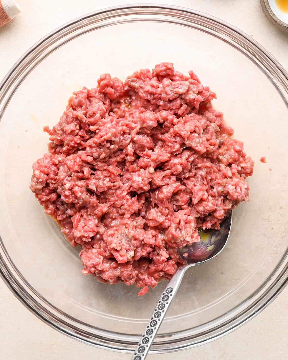 how to make Gluten Free Meatballs - ground beef, egg and milk in a bowl after mixing