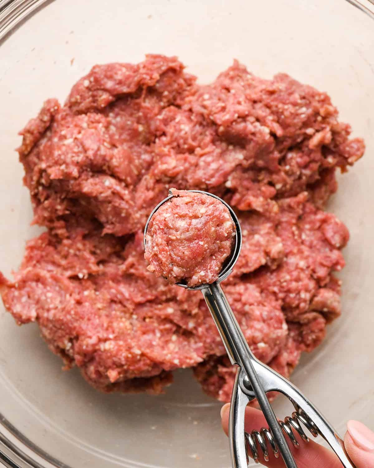 how to make Gluten Free Meatballs - measuring meatball mixture with a cookie scoop