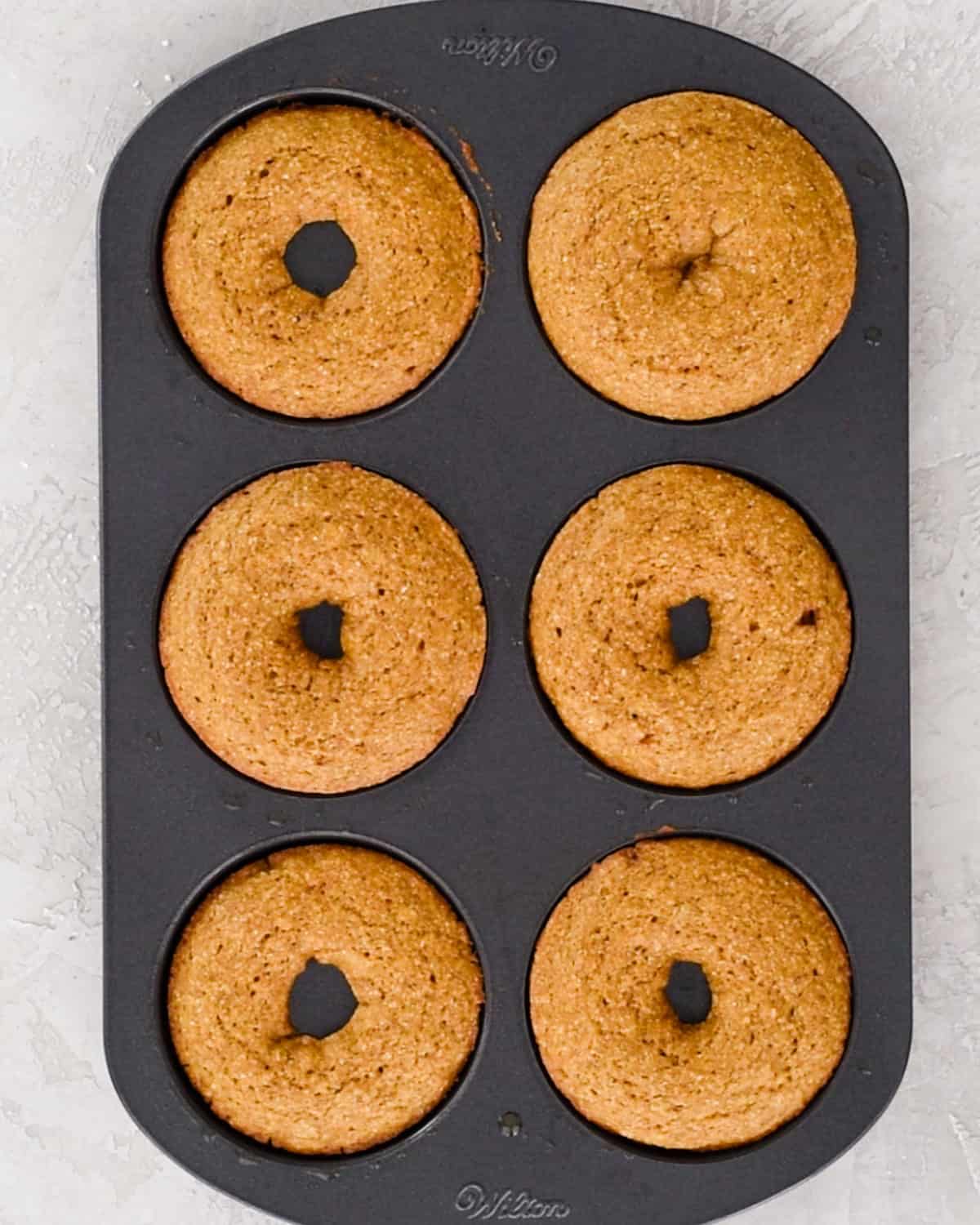 Baked Pumpkin Donuts in a donut pan after baking