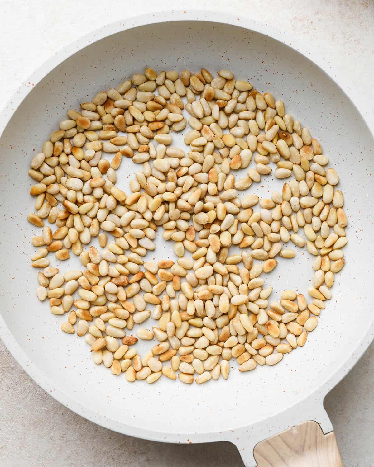 How to Make Pesto Sauce - toasted pine nuts in a pan