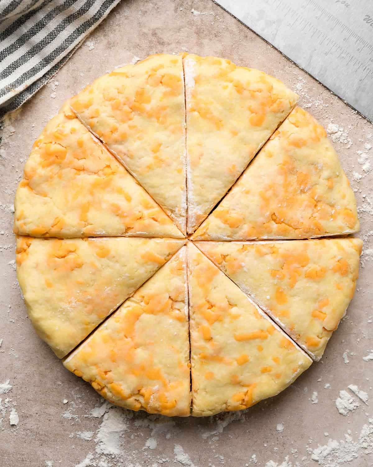 how to make cheese scones - round disc of dough cut into 8 pieces