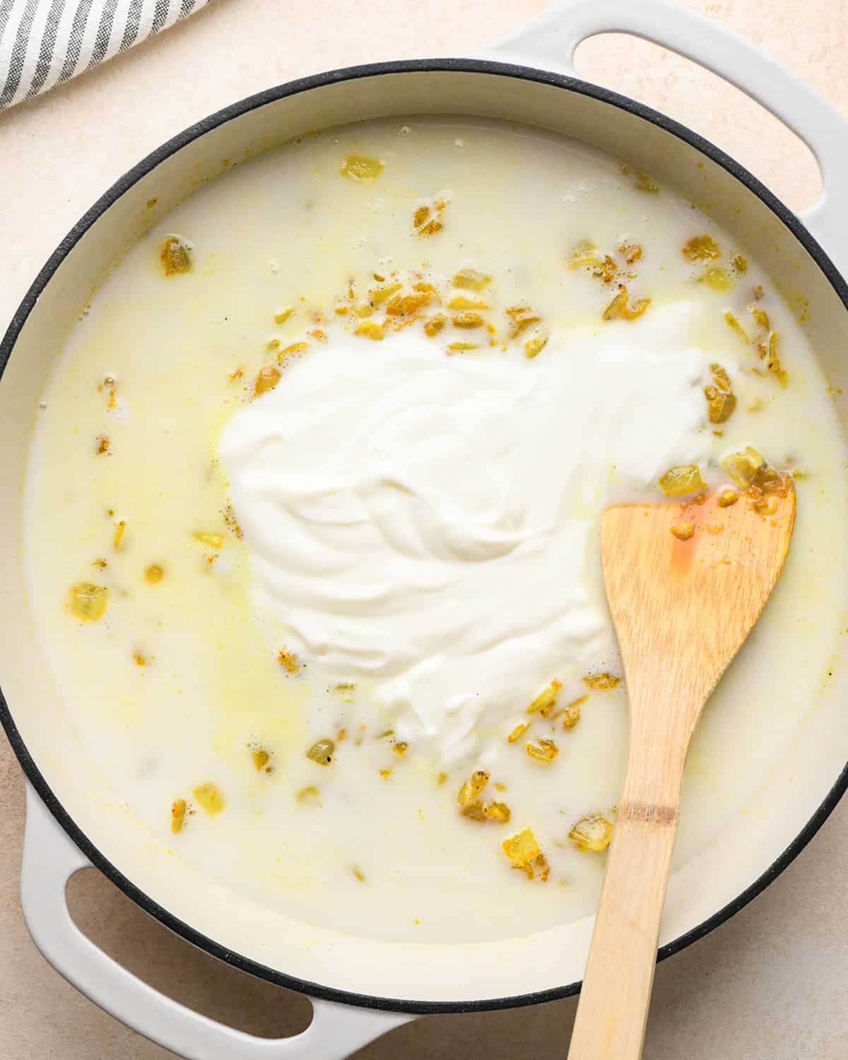 How to Make Chicken Curry - wet ingredients added to onions in the pot before stirring