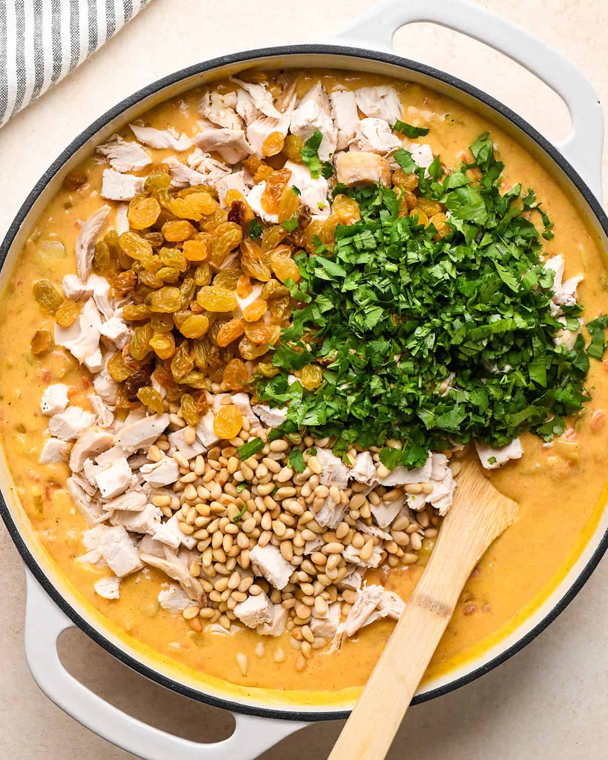 How to Make Chicken Curry - chicken, raisins, cilantro and pine nuts added before stirring