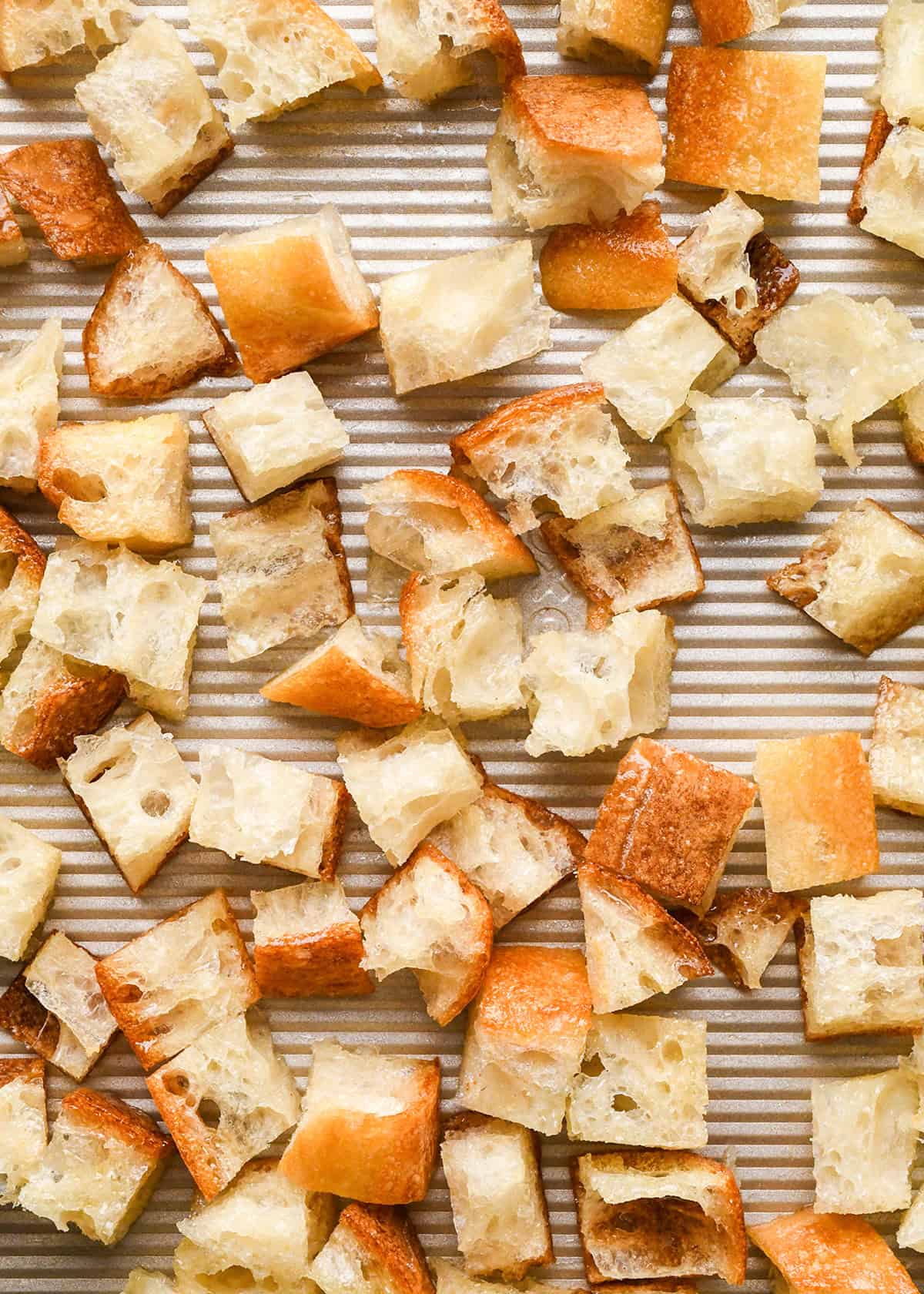 How to Make Croutons - bread spread onto a baking sheet before baking