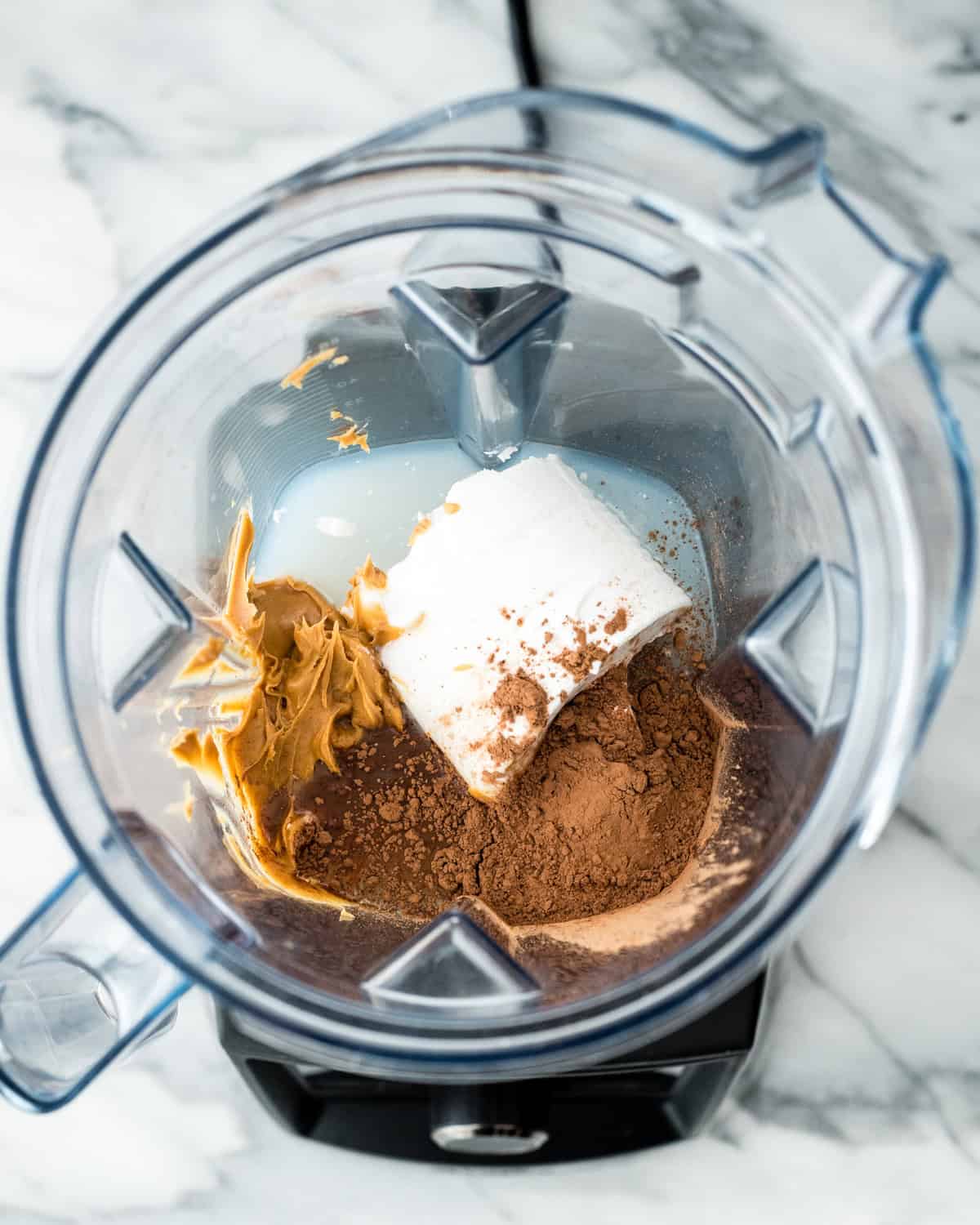 making Dairy Free Chocolate Peanut Butter Ice Cream in a blender container - ingredients added before blending