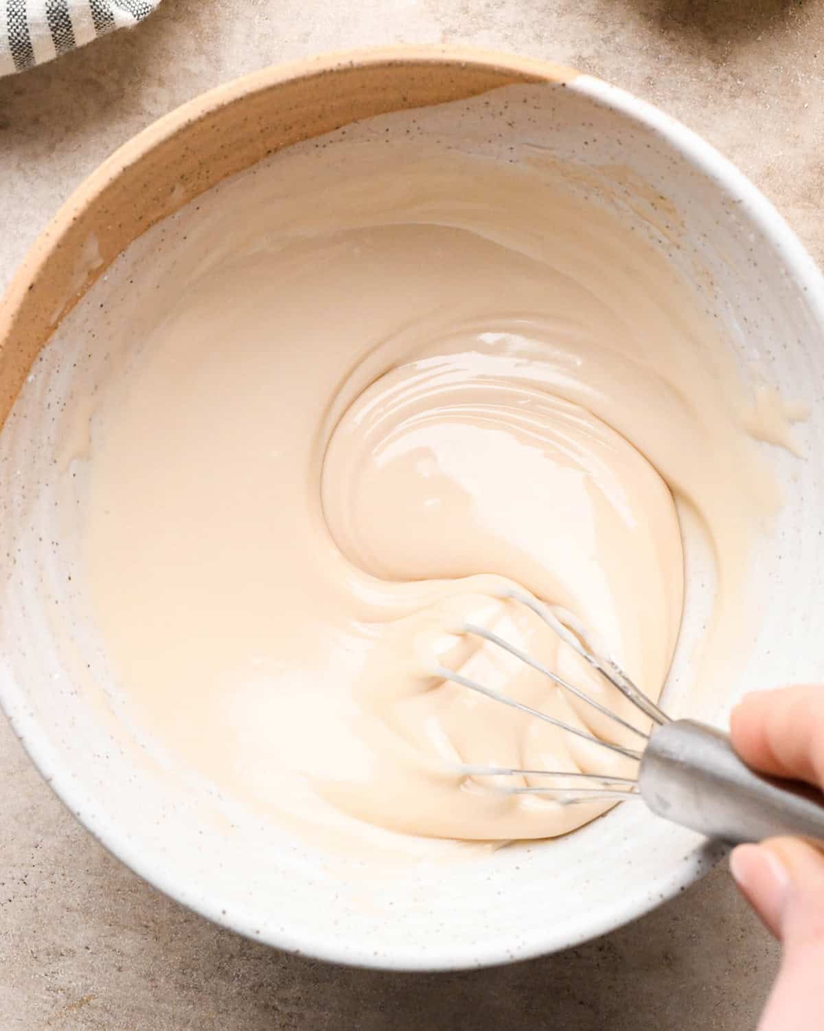 Vanilla Icing in a bowl being whisked 