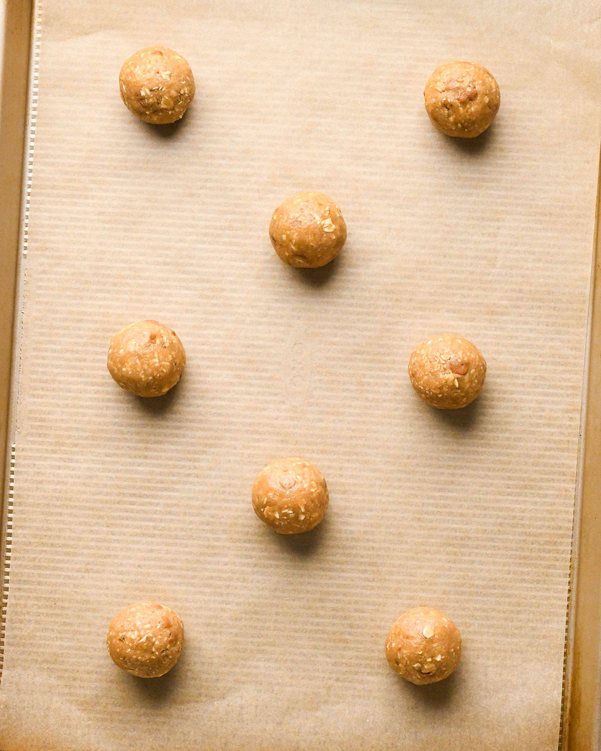 How to Make Iced Oatmeal Cookies - 8 balls of dough on a baking sheet before baking