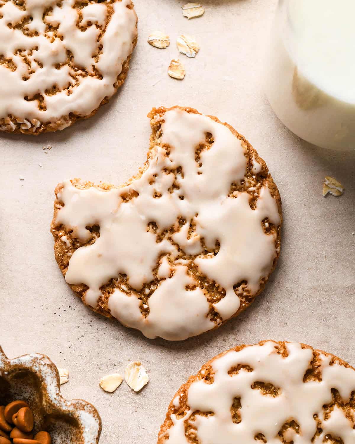 3 Iced Oatmeal Cookies, one with a bite taken out of it