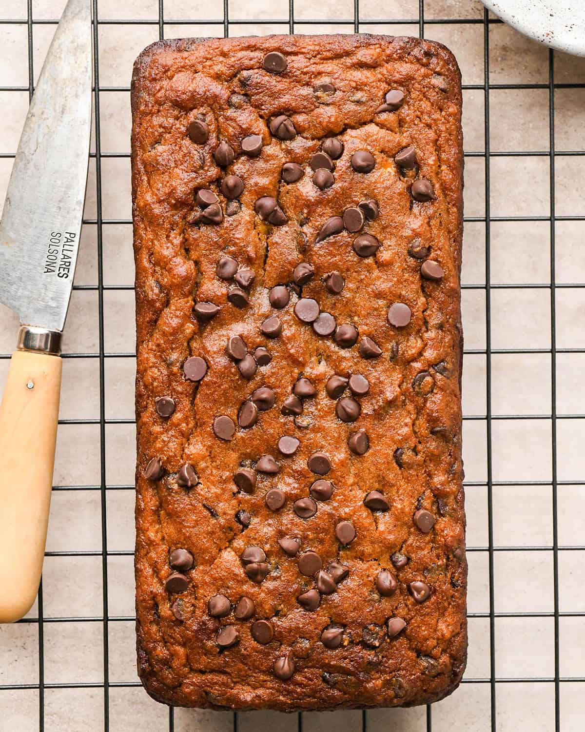 a loaf of Paleo Banana Bread on a wire cooling rack