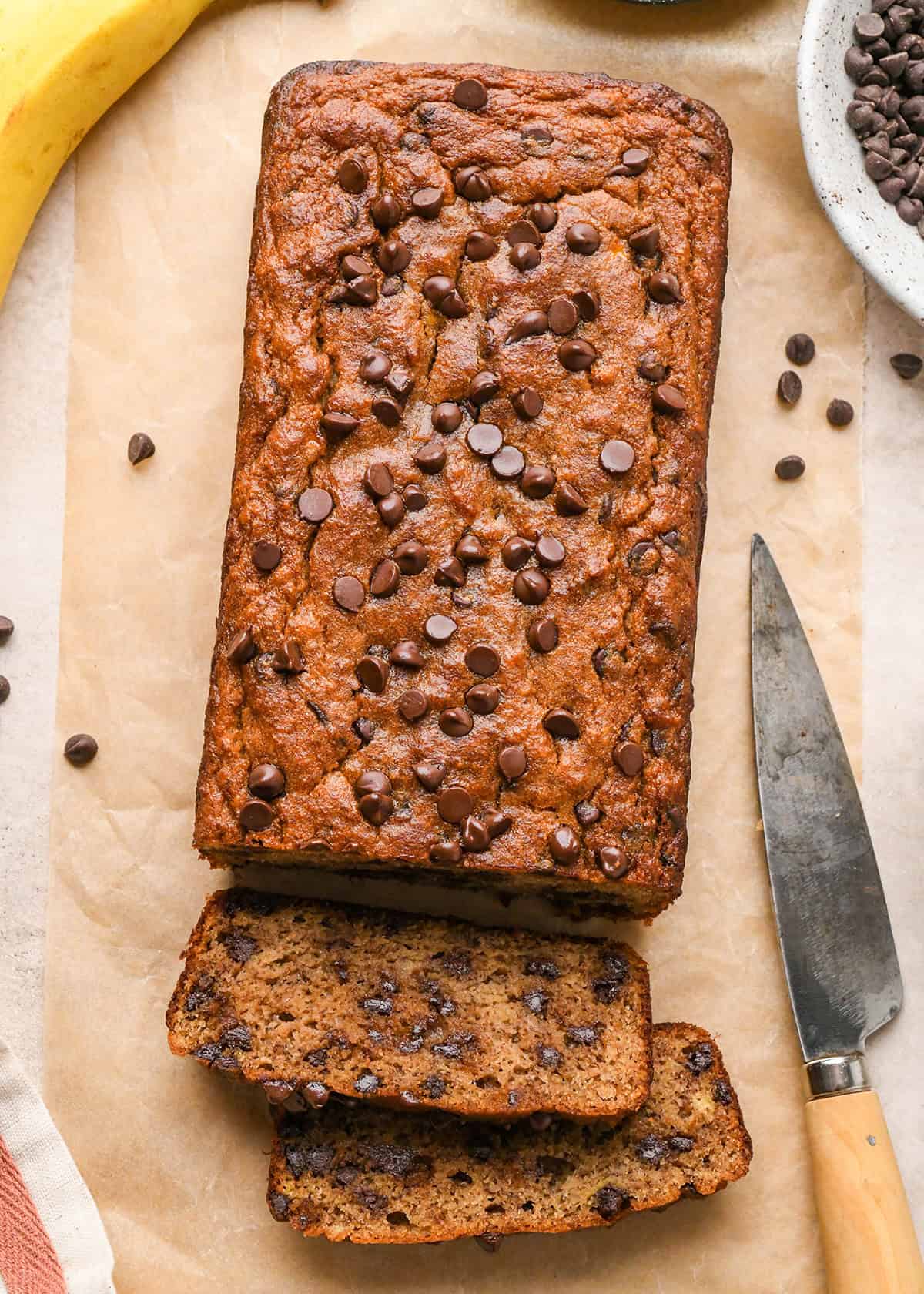 a loaf of Paleo Banana Bread with two slices cut out of it